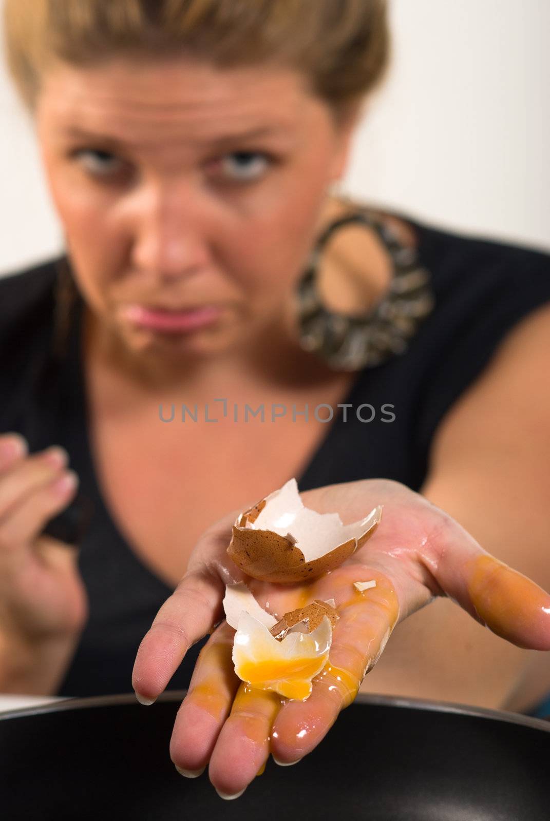 Cheeky blond playing around with eggs and pans