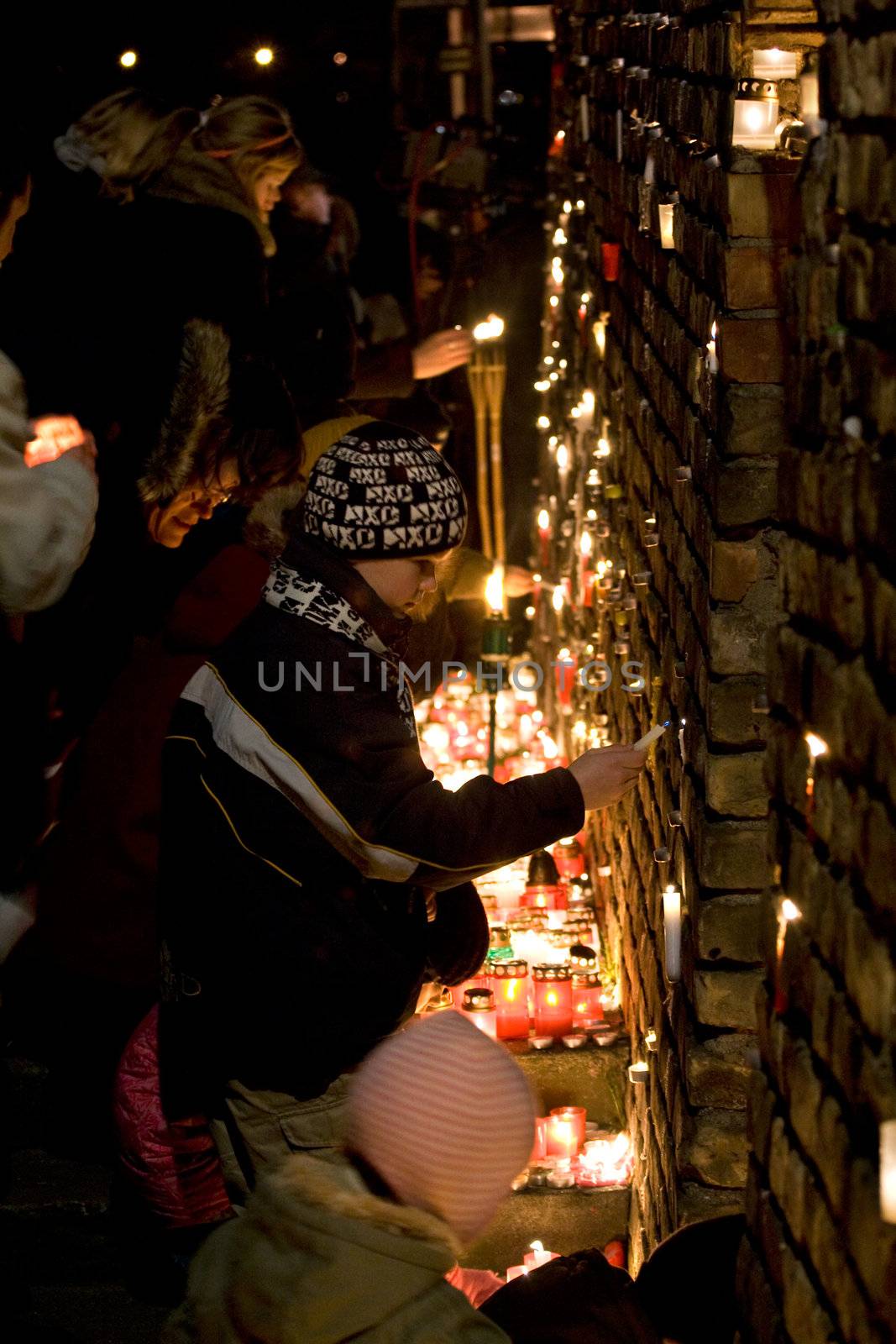 RIGA, LATVIA - NOVEMBER 11: Soldiers Memorial Day. People light candles at Prezident's castle wall to commemorate victory over the Russian and German militia. This victory was important in the birth of Latvia as an independent nation. November 11, 2009 in Riga