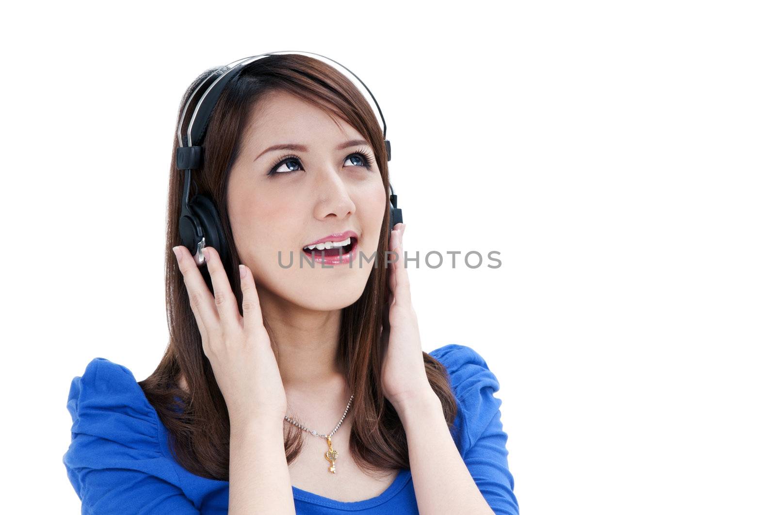 Portrait of a beautiful young woman listening to music over white background.