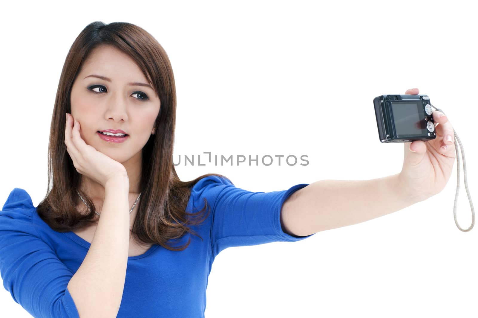 Portrait of a cute young woman taking a self portrait over white background.