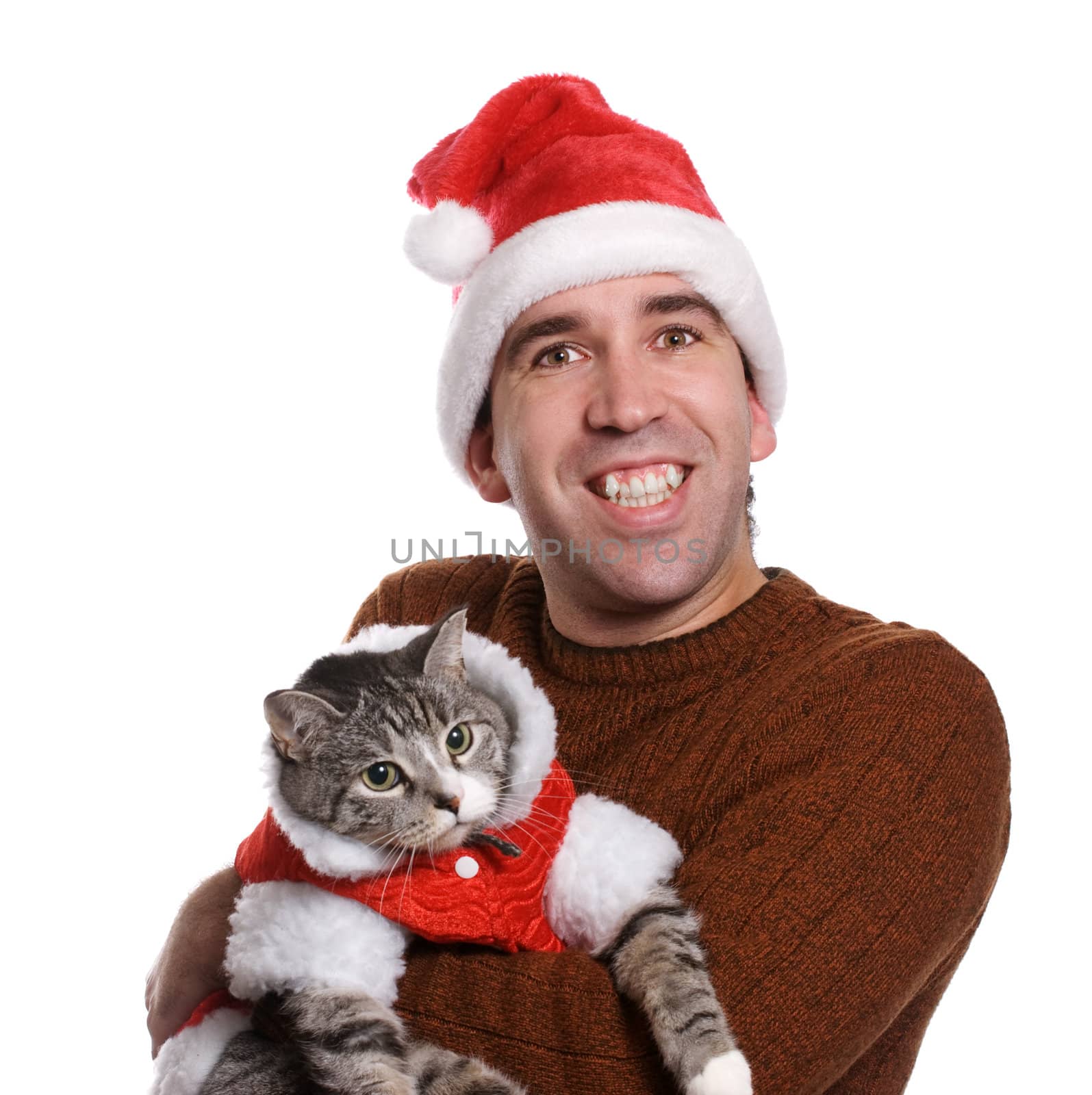 A smiling young man wearing a santa hat and holding his cat, isolated against a white background