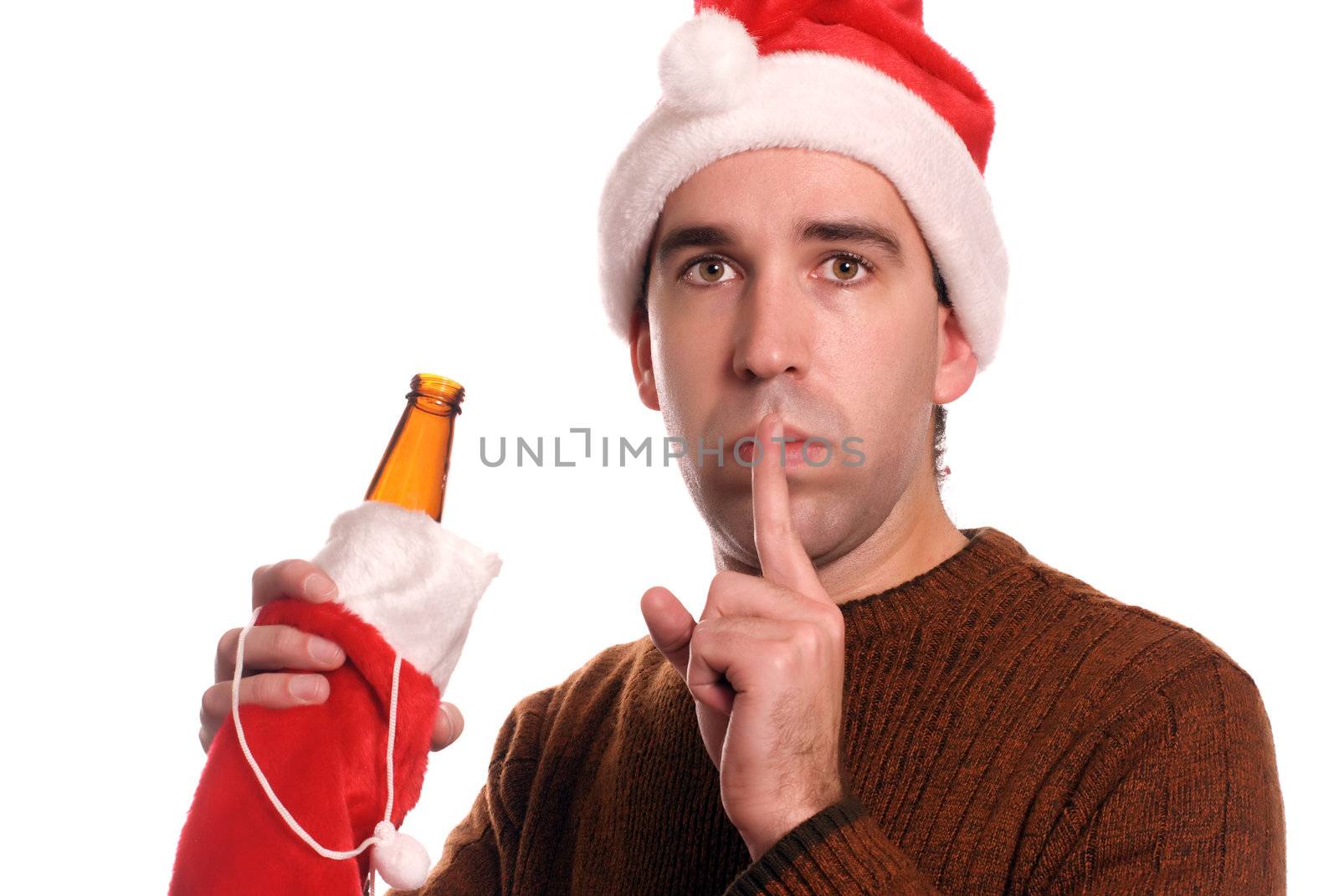 Concept image of a young man wearing a Santa hat and holding a beer, telling the viewer to keep his secret about his problem