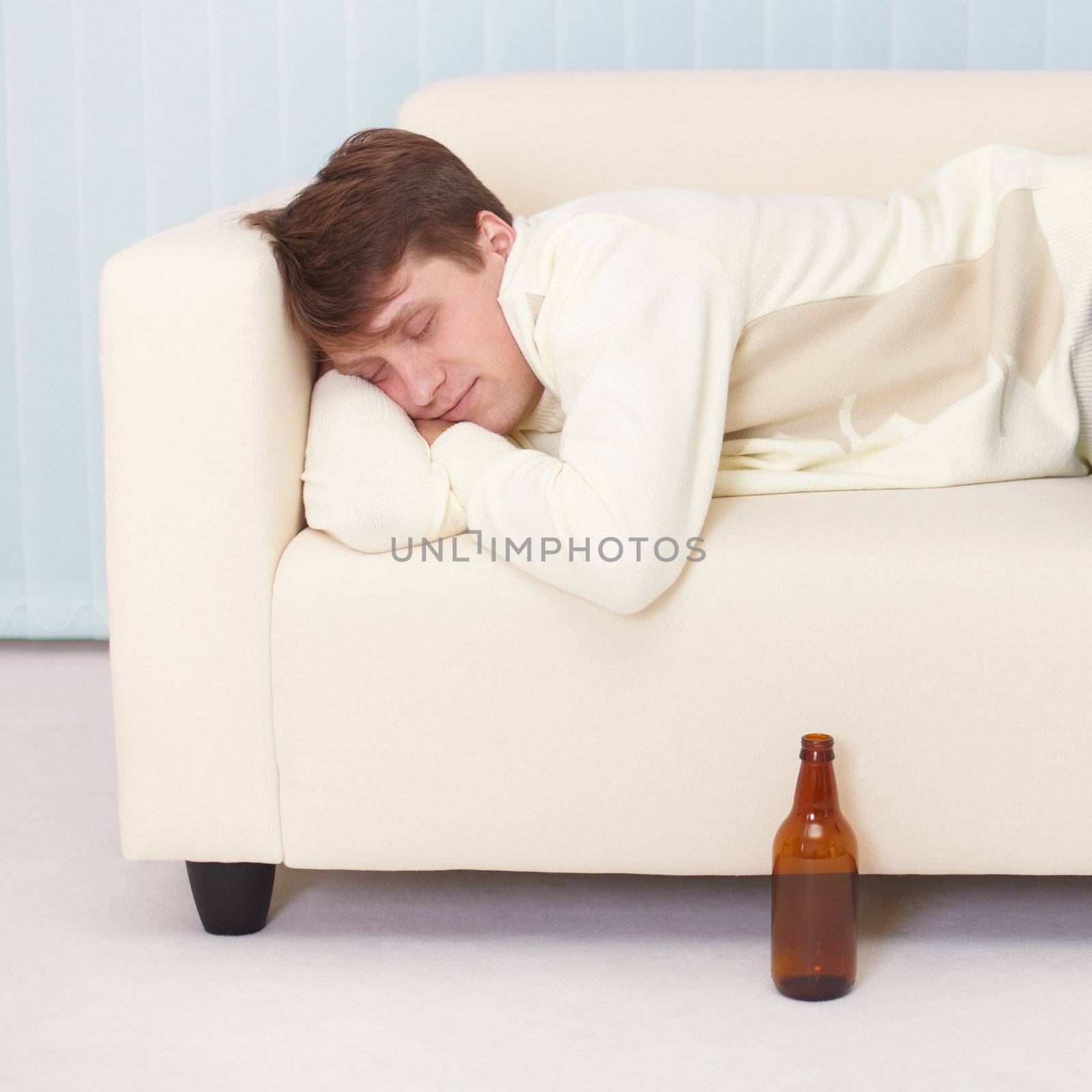 Person comfortable sleeps on sofa having got drunk beer by pzaxe