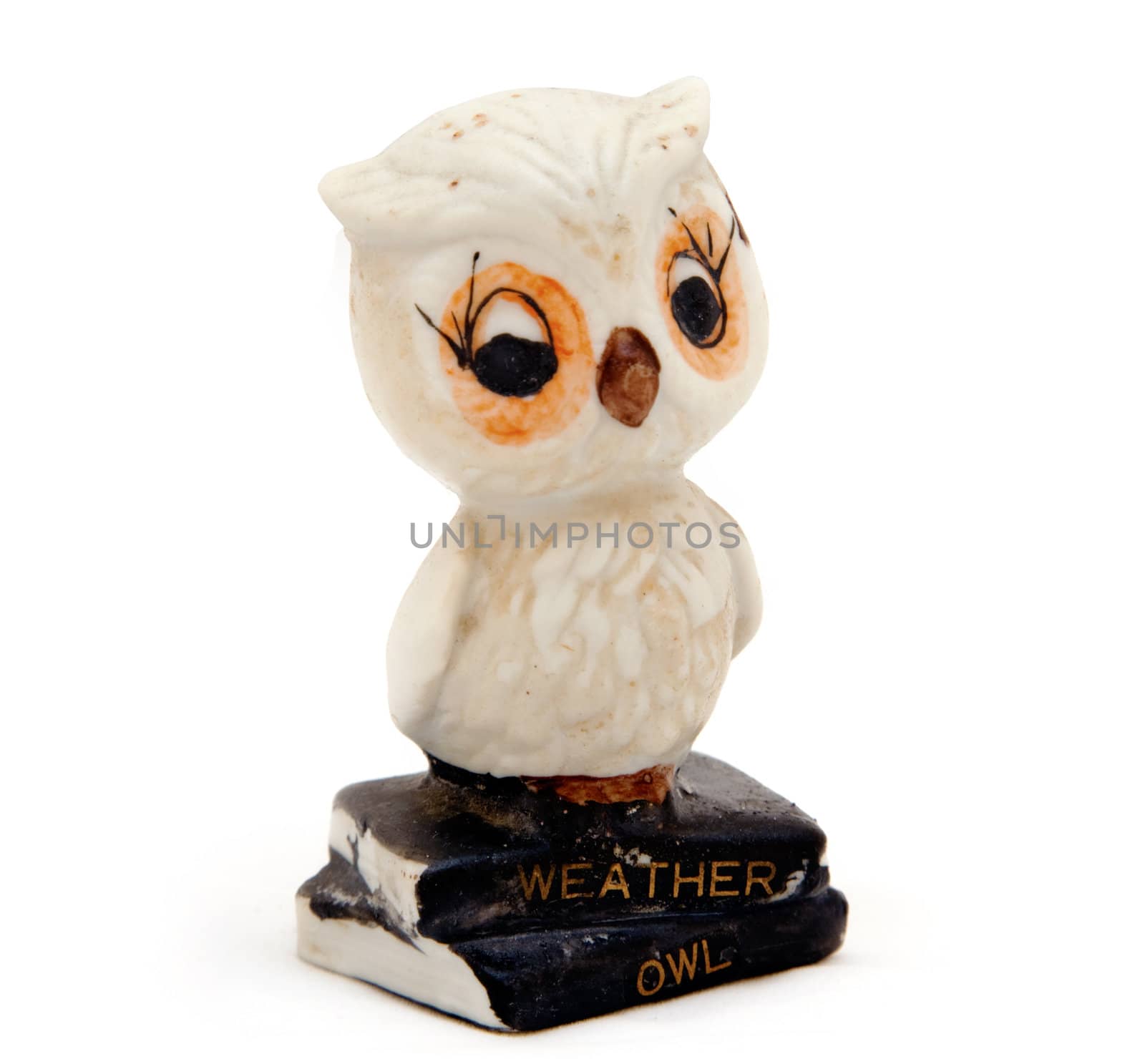 An old ceramic weather owl that changes color depending on the weather, isolated against white.
