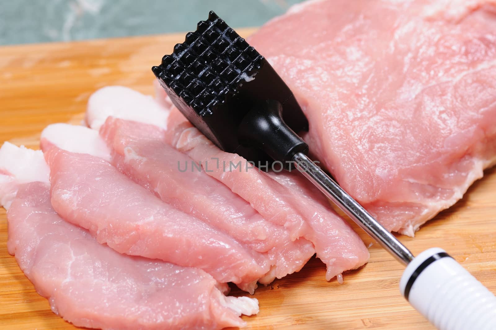 The cook prepares a chop from pork