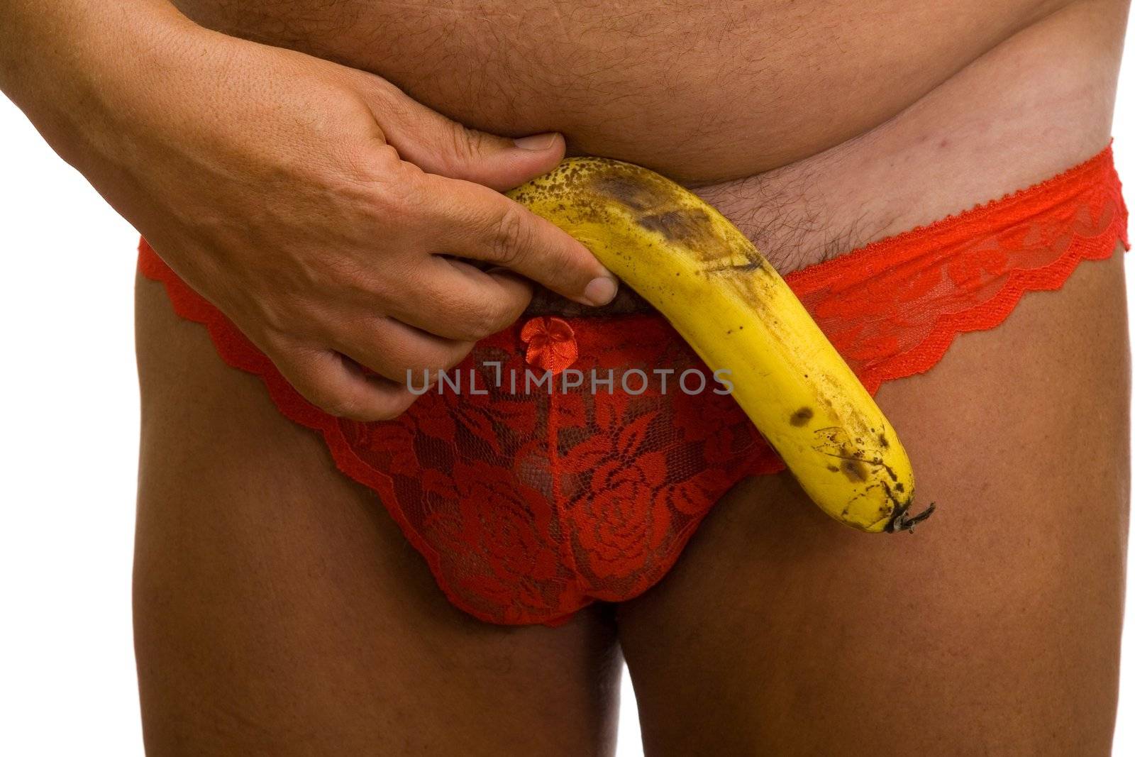 Male front with banana in red fishnet women's panties on a white background
