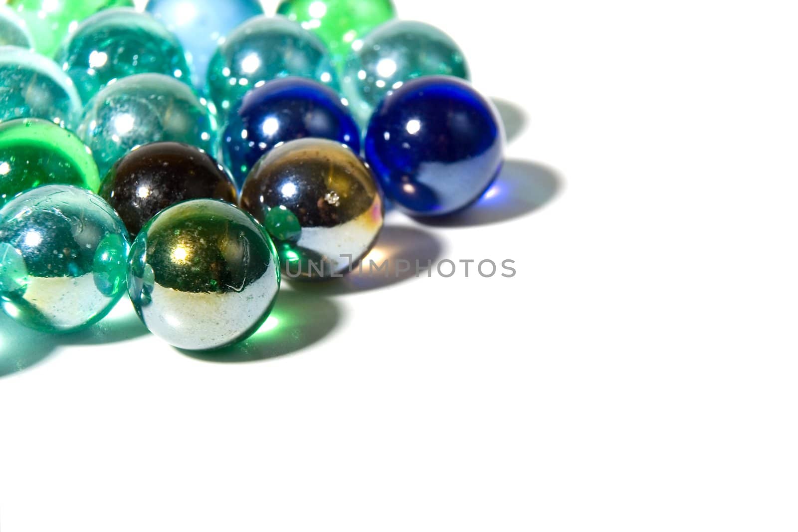 Studio shot of varicolored beautiful glass marbles on a white background