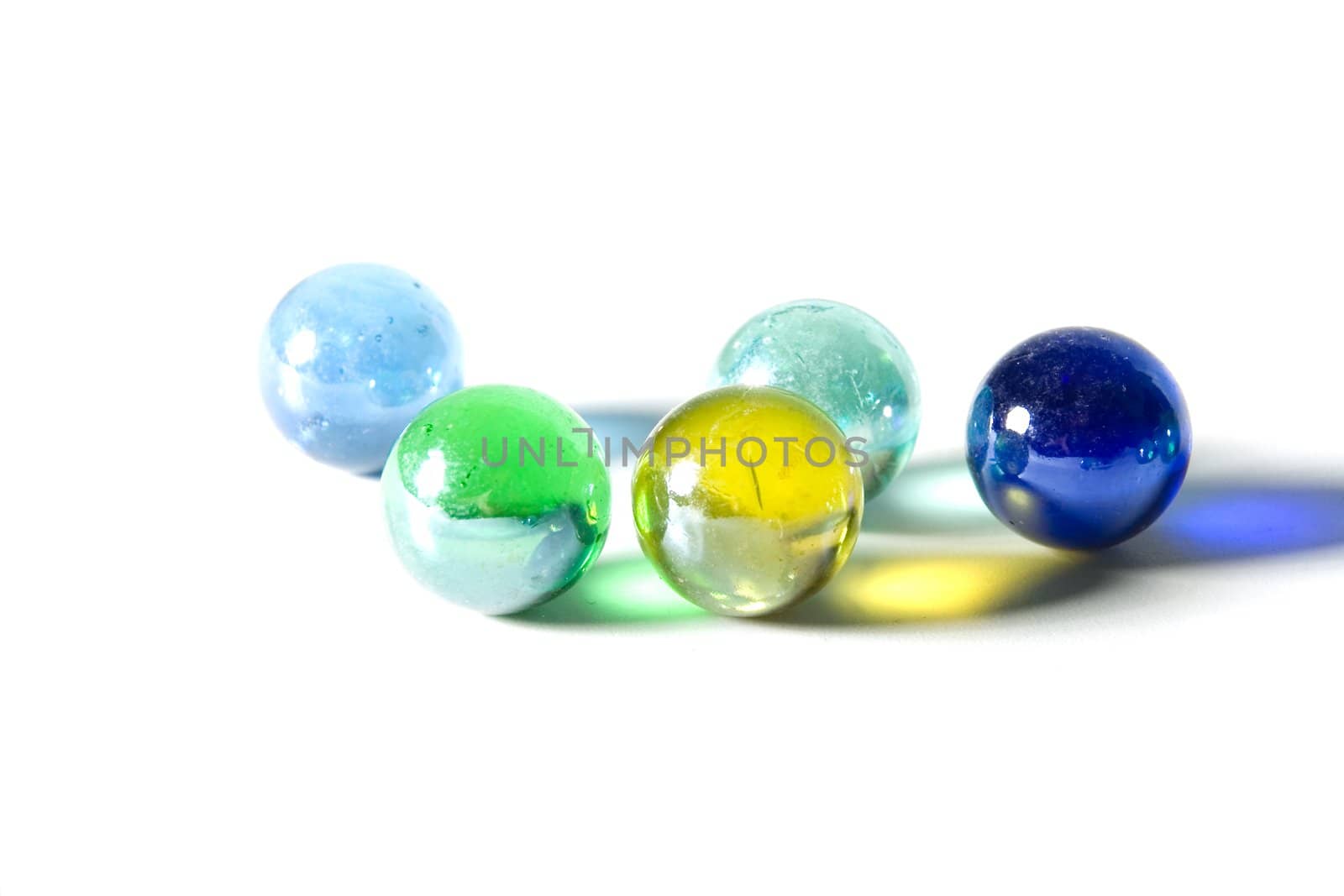 Studio shot of varicolored beautiful glass marbles on a white background