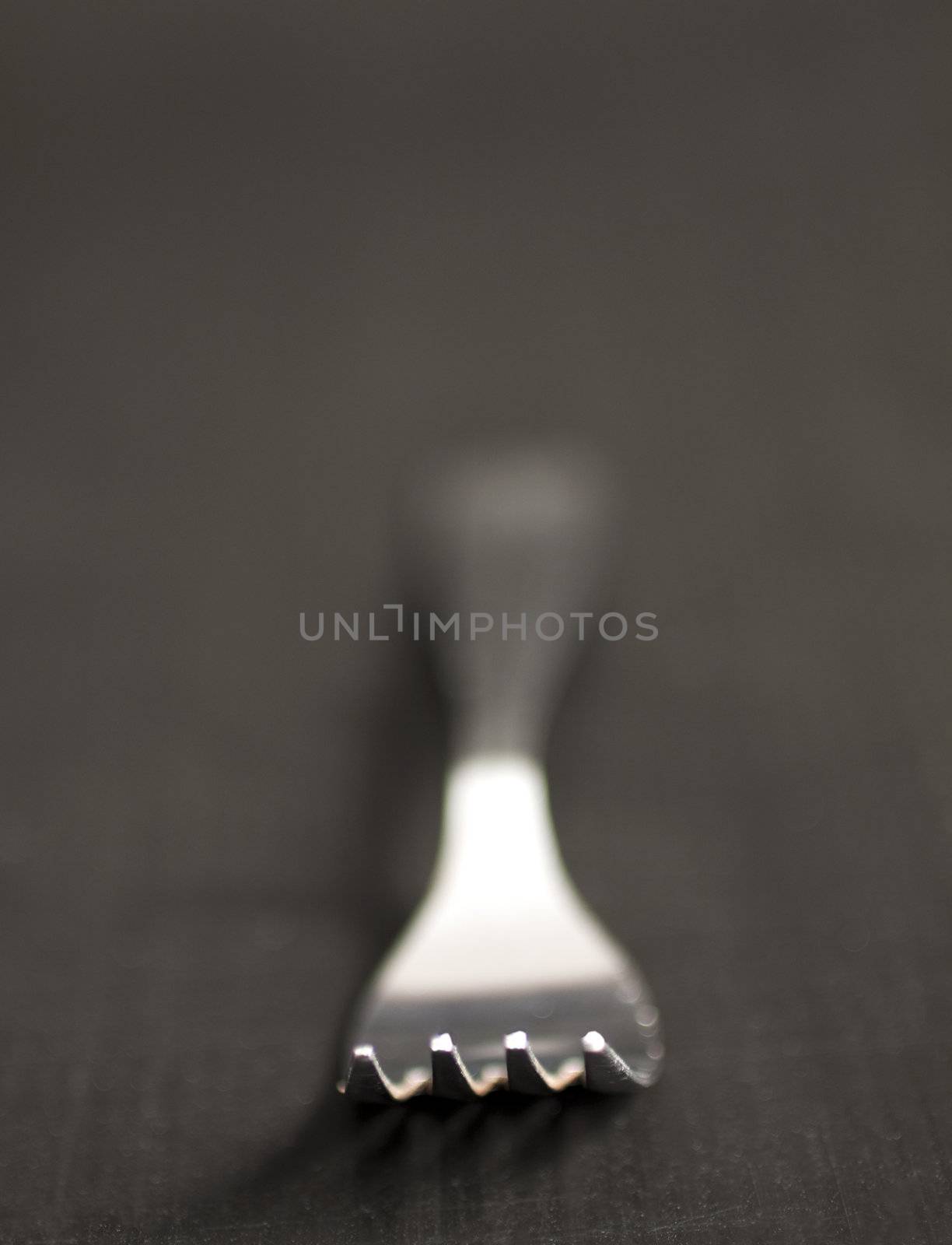 Close up of a fork with DOF black background