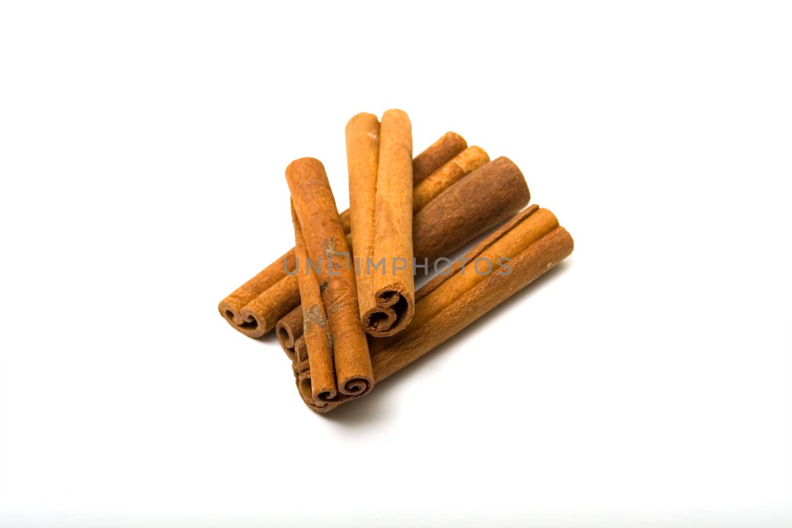 A few dry sticks of cinnamon on a white background