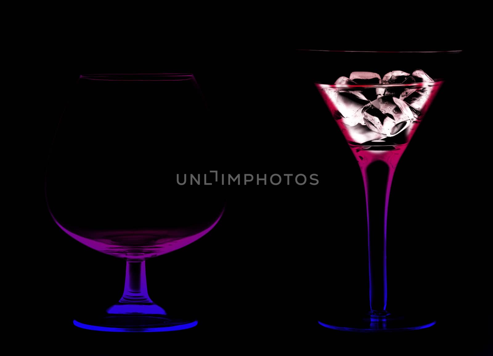 Wine Glasses with a cocktail and ice on a black background
