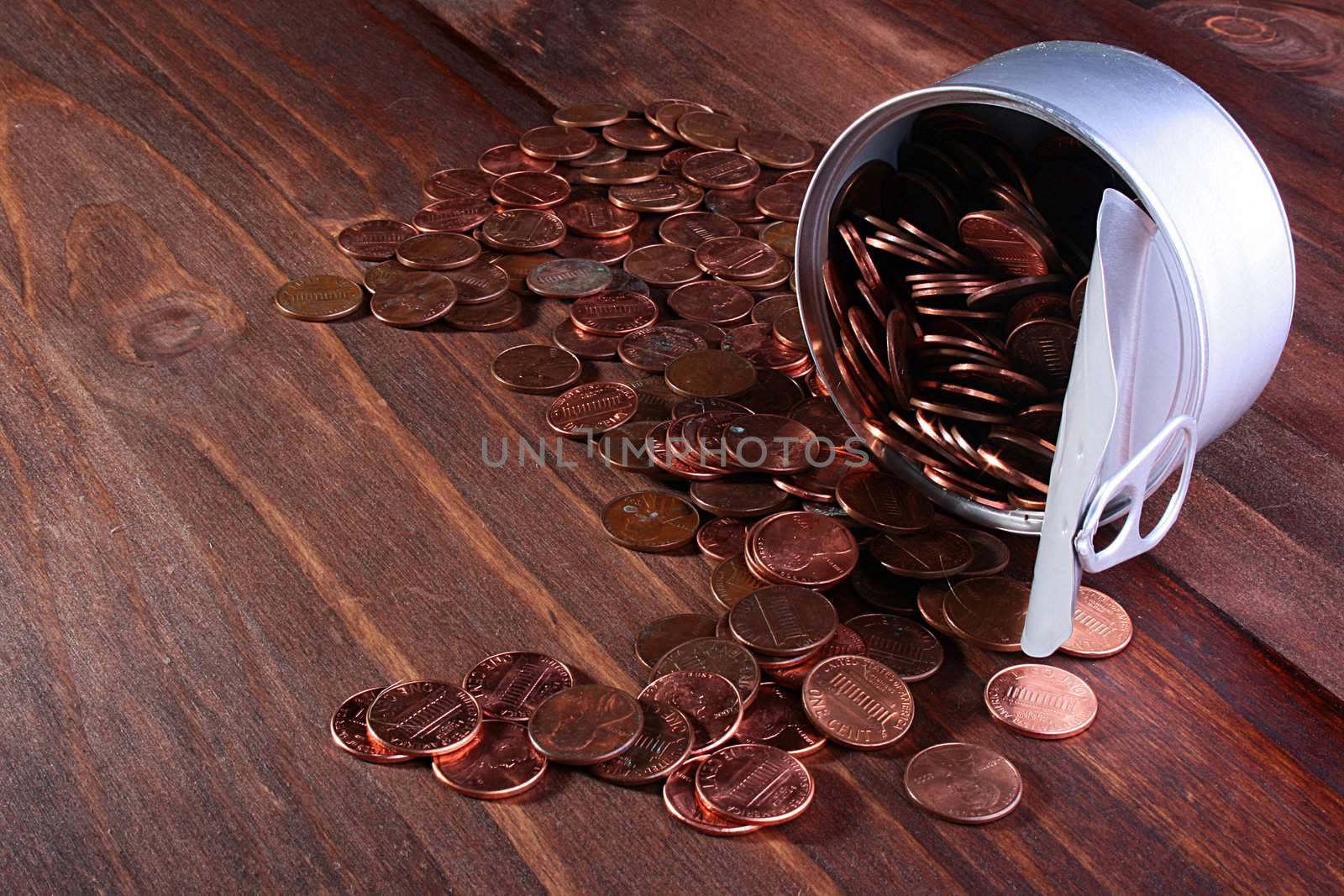 The American cents are poured out from tin opened banks on a wooden table.