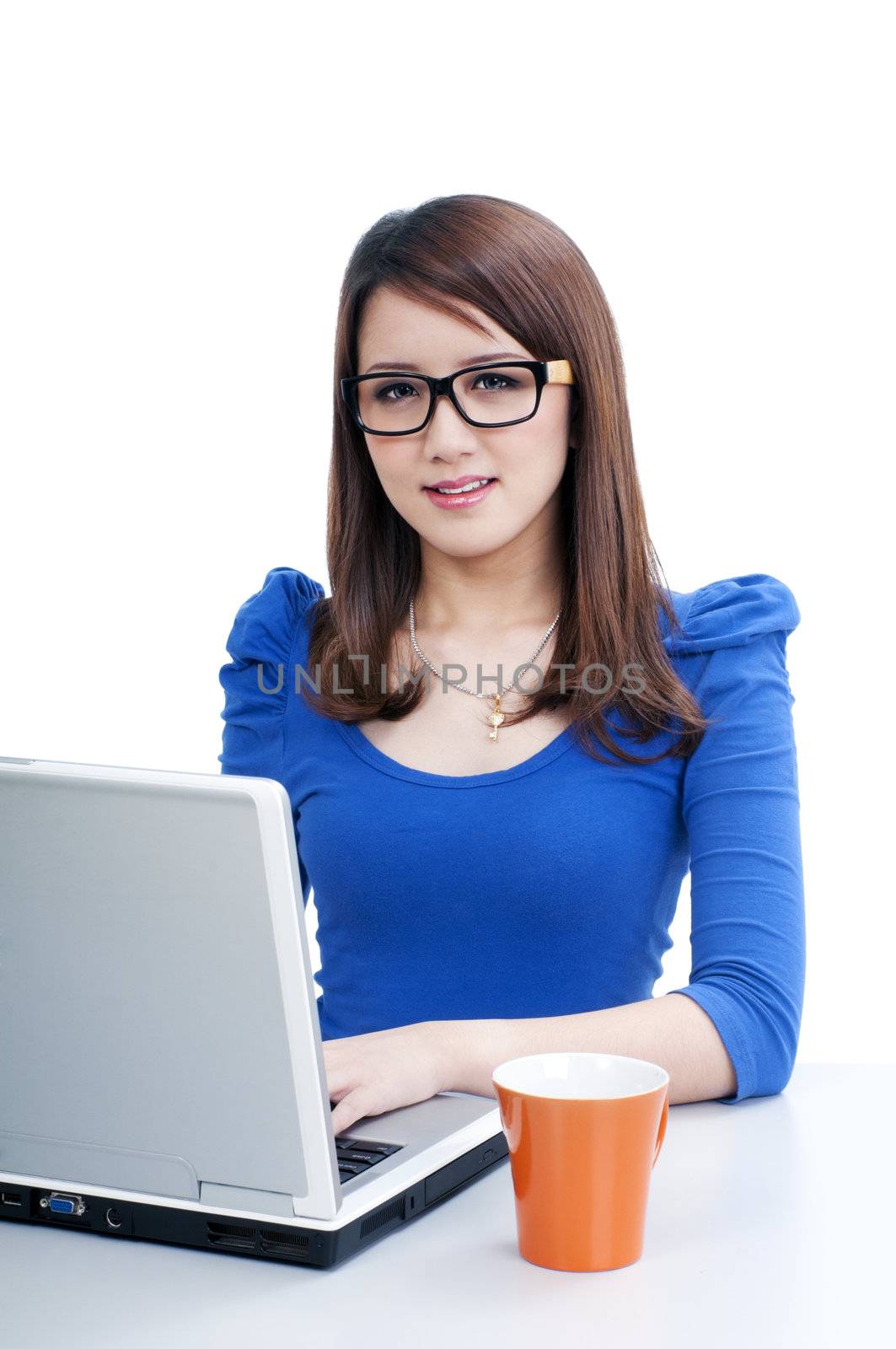 Portrait of an attractive young woman using laptop over white background.