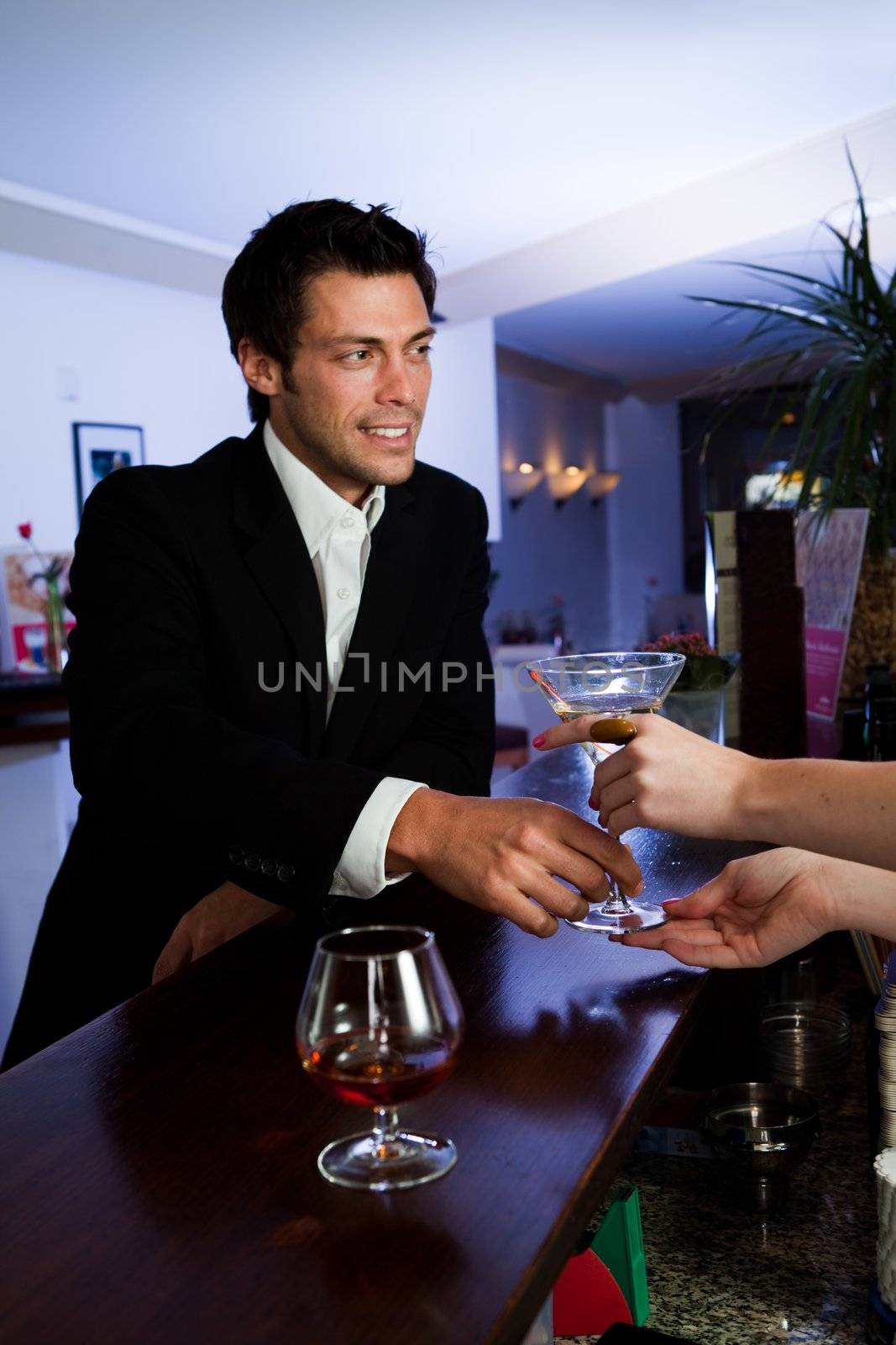 Man ordering martini. Focus on the hands