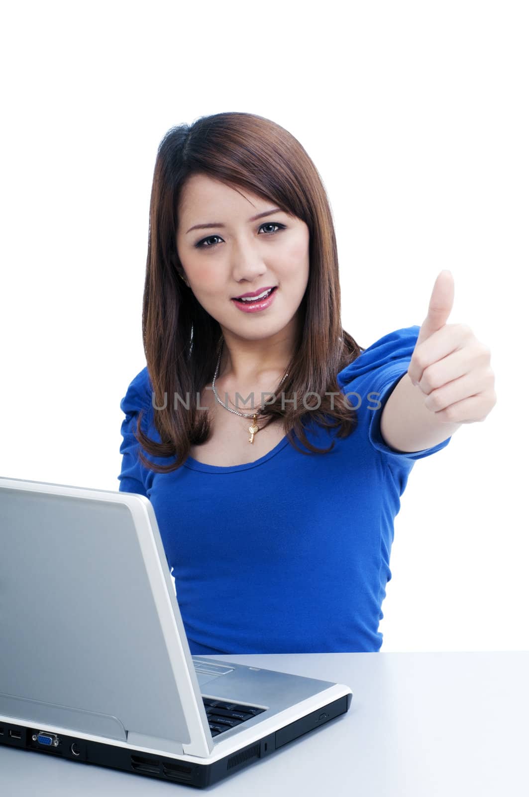 Portrait of an attractive young woman with laptop and giving thumb up  over white background.