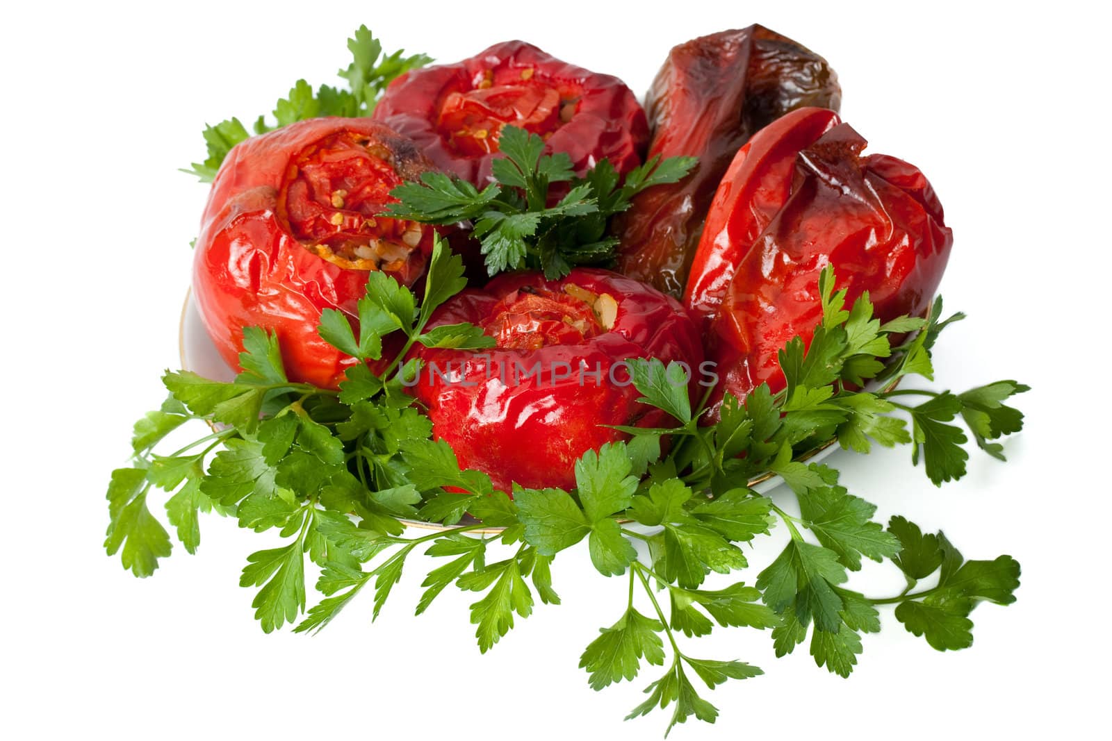 Five red stuffed peppers with rice and fresh parsley