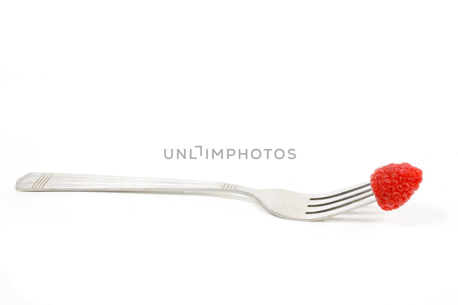 Fresh raspberry on fork over white background