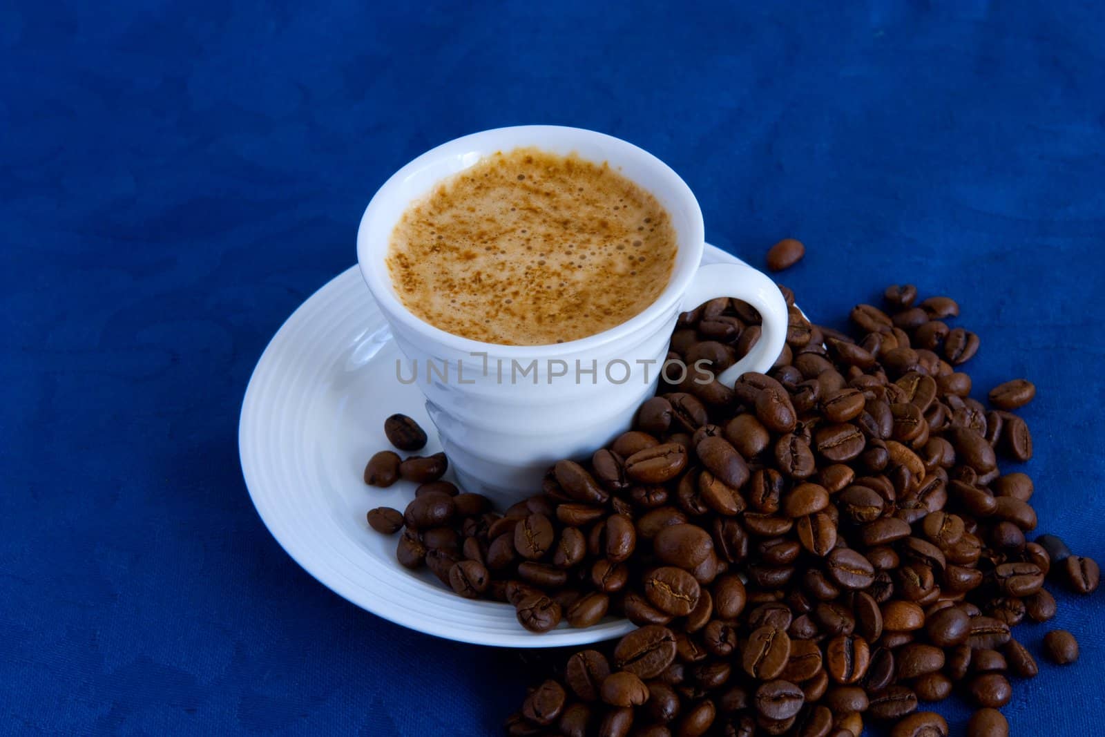 cup with coffee and grain expressed on blue background