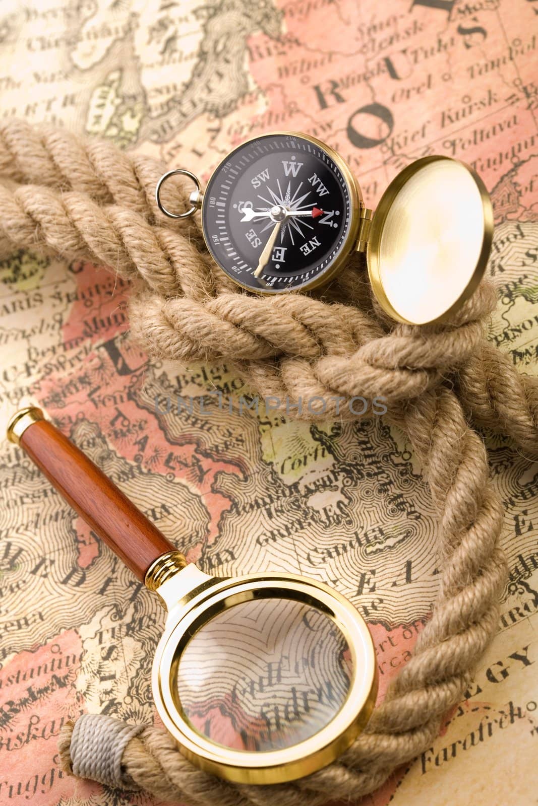 Old compass on map by shiffti