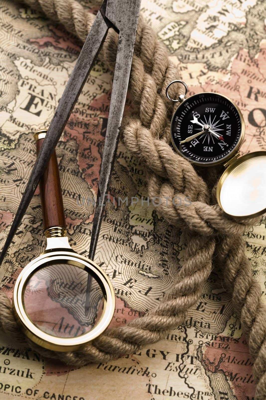 Old compass on map by shiffti