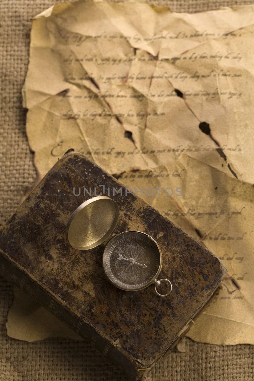 A beautiful golden compass on an old letter