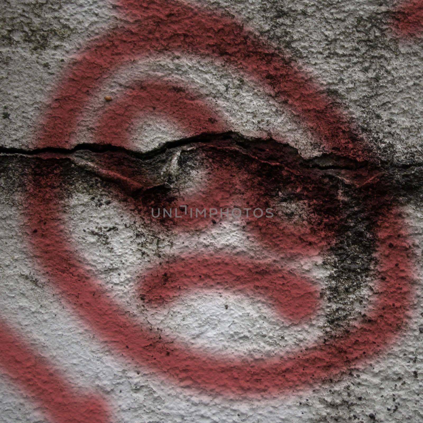 Dirty looking grunge background with red graffiti sad face and copy space