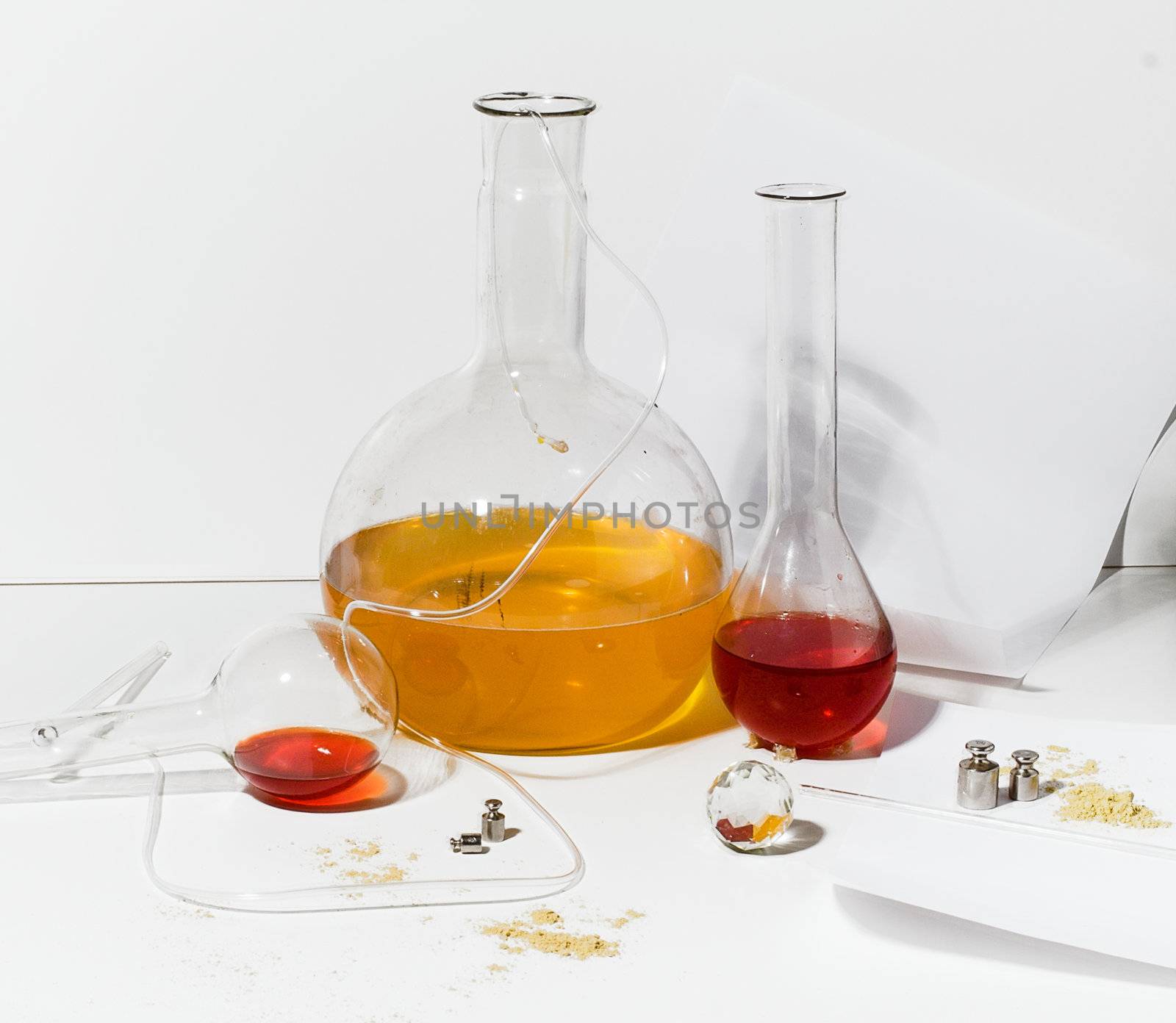 Items from research lab, surrounded by flasks whit colored liquids, on 
light white background. You can place text or chemical signs on this 
backround.
