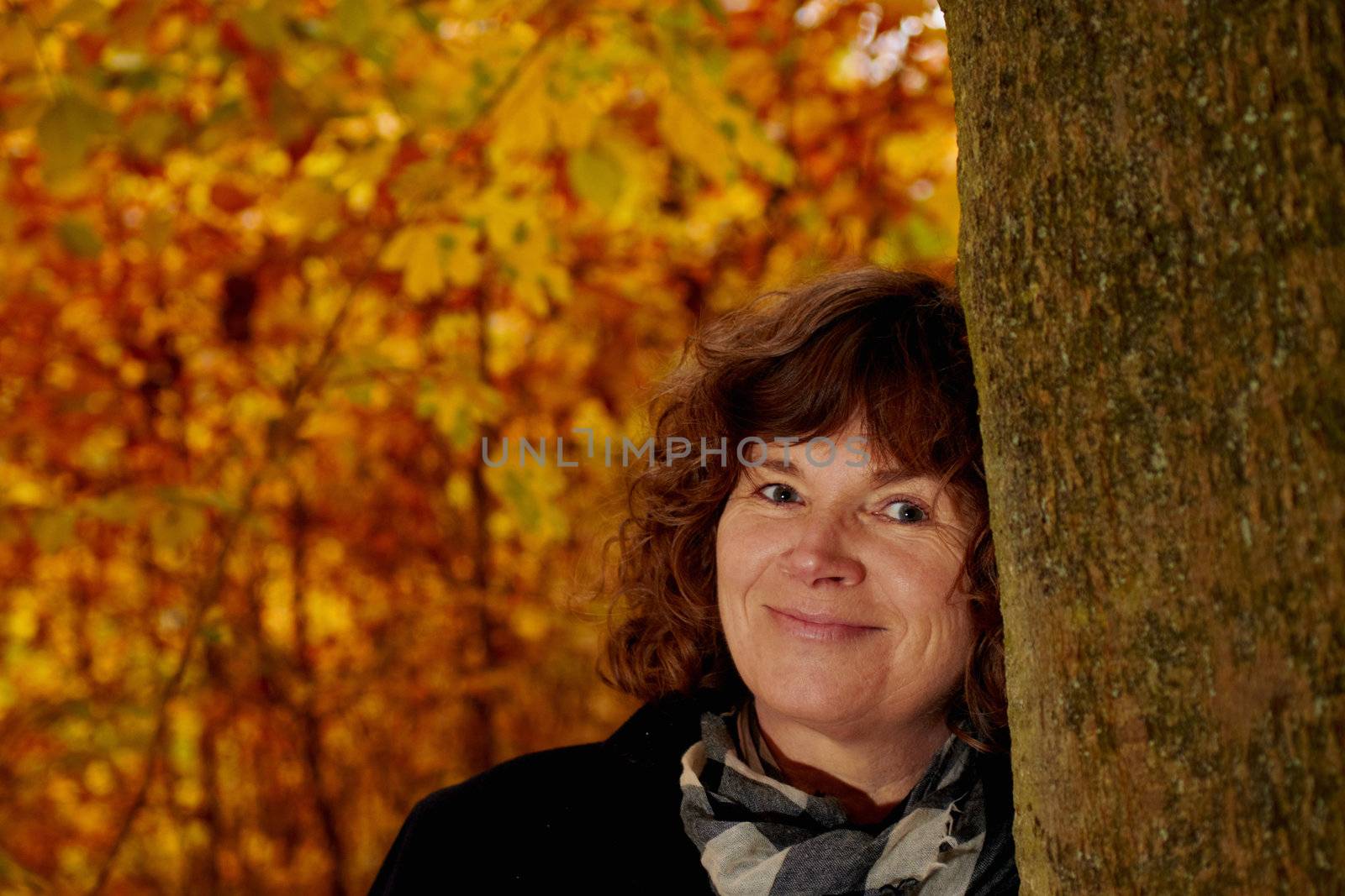 Fall - mugshot of mature woman looking at you by FreedomImage