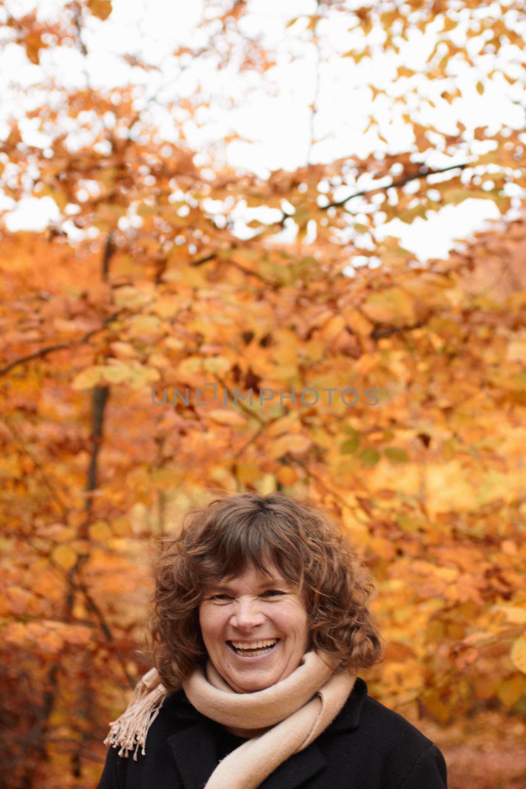 Autumn - Joyful middle aged woman laughing