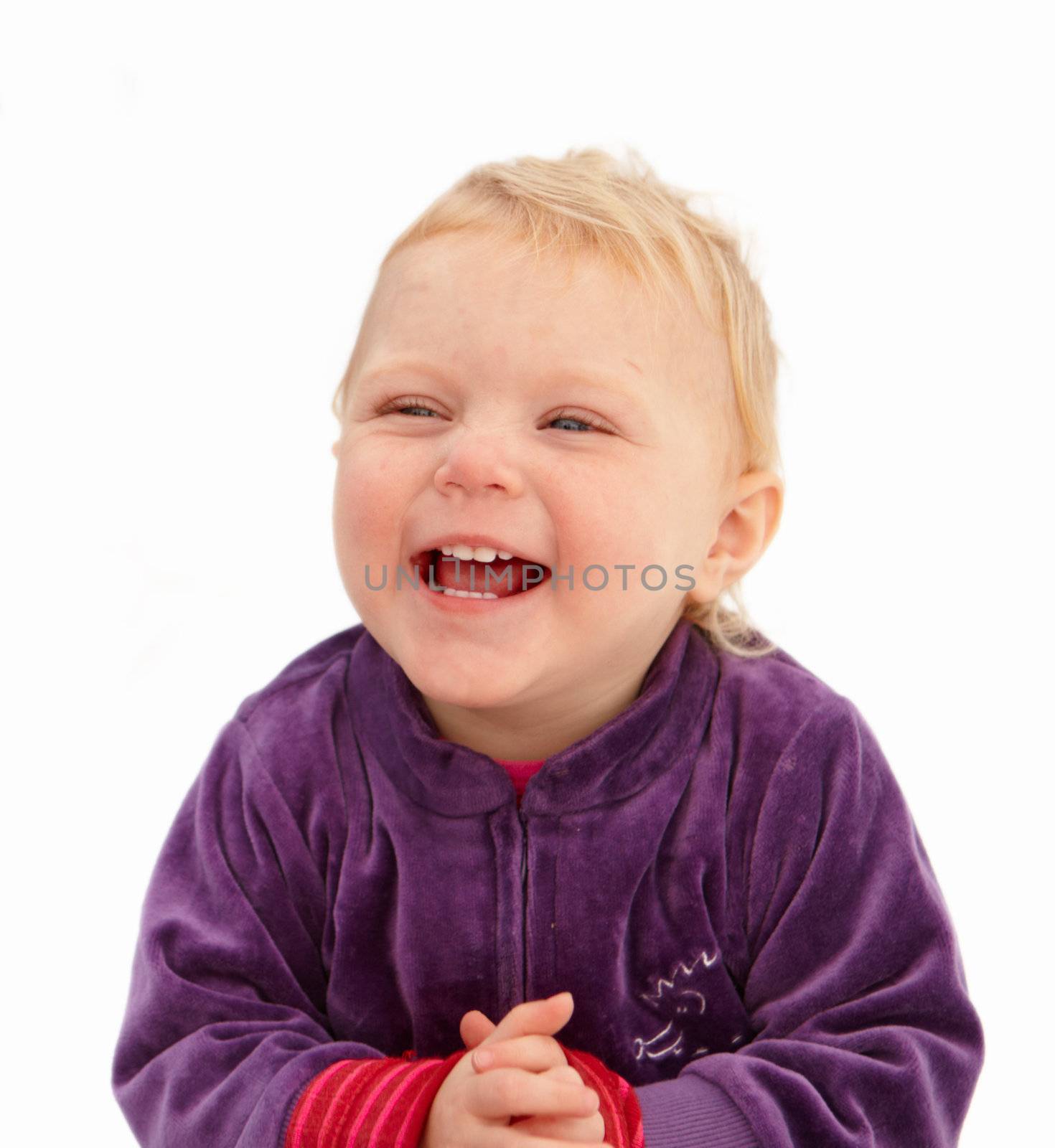 Cute baby girl smiling on white background by FreedomImage