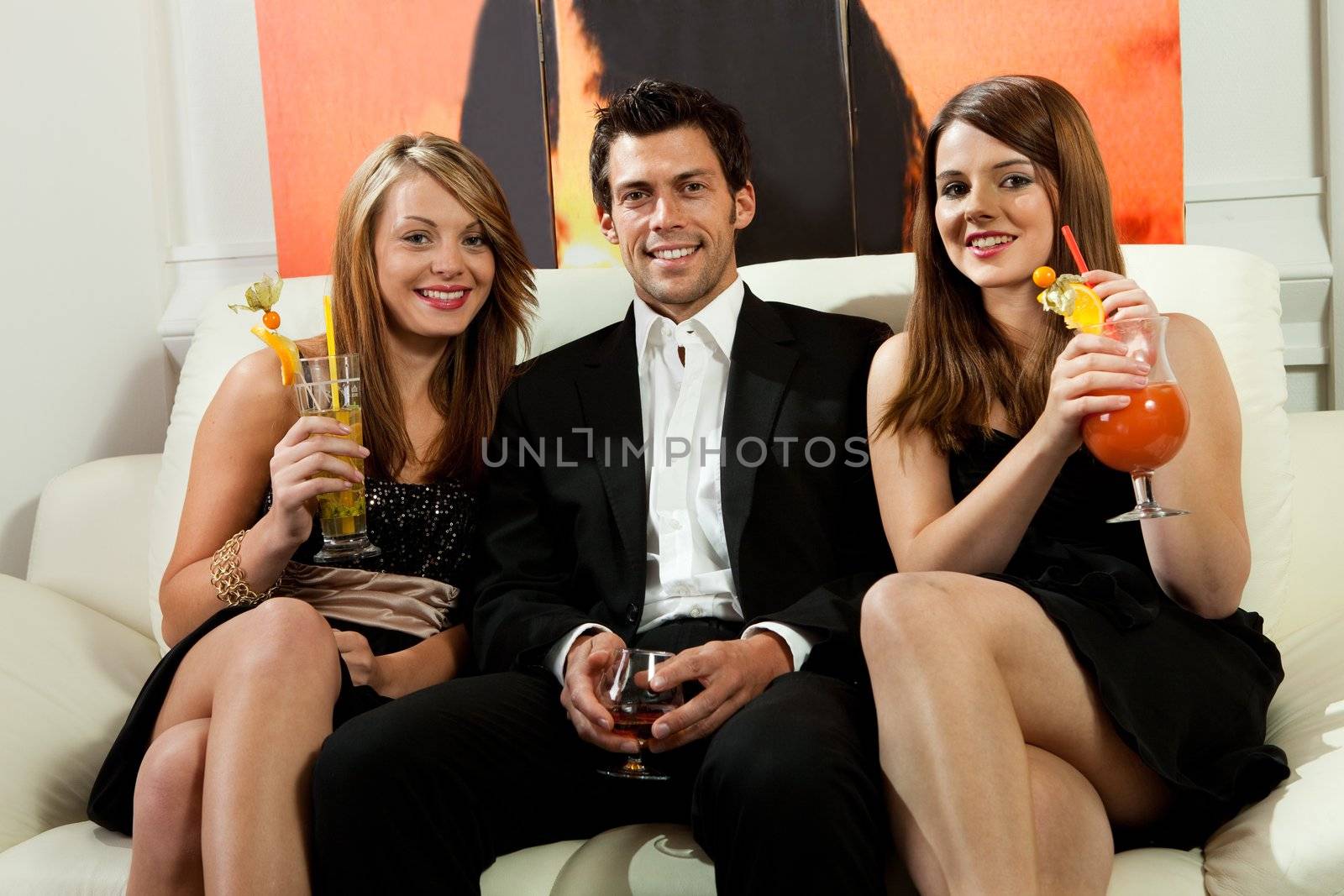 Friends having good time together with cocktails