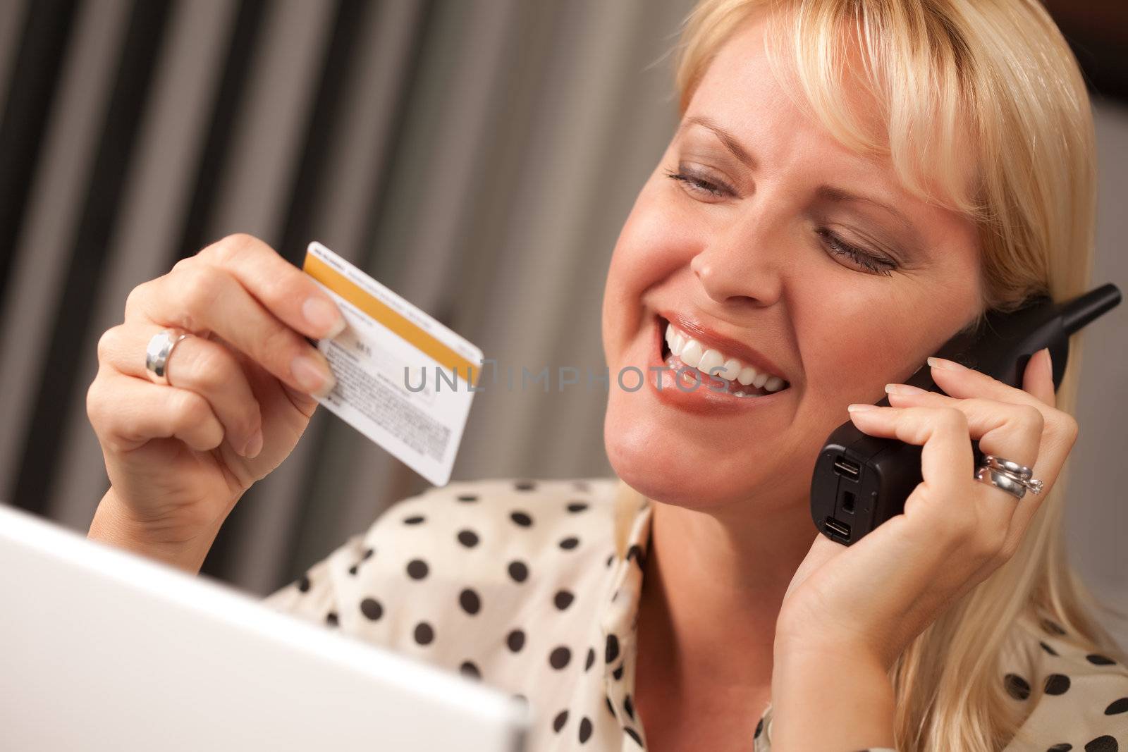 Beautiful Woman on the Phone Holding Her Credit Card.