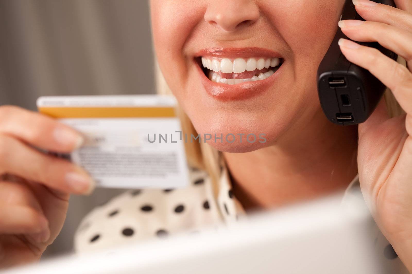 Beautiful Woman on the Phone Holding Her Credit Card.