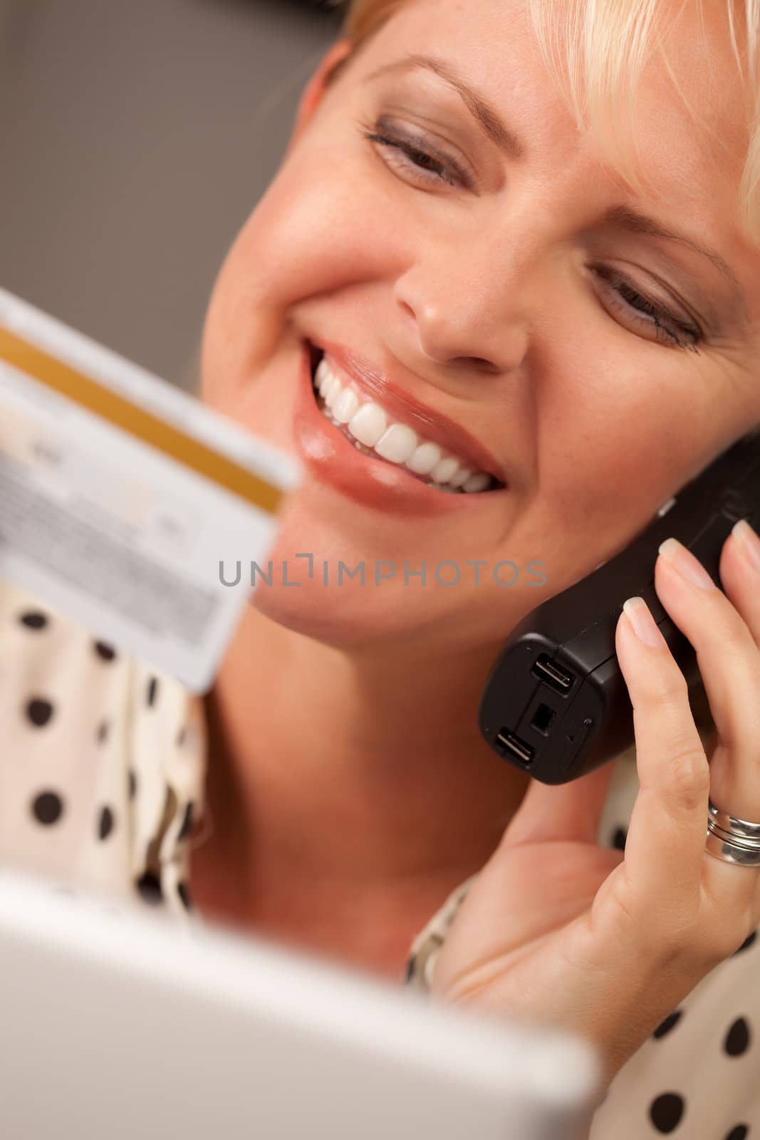 Beautiful Woman on Phone Holding Credit Card by Feverpitched