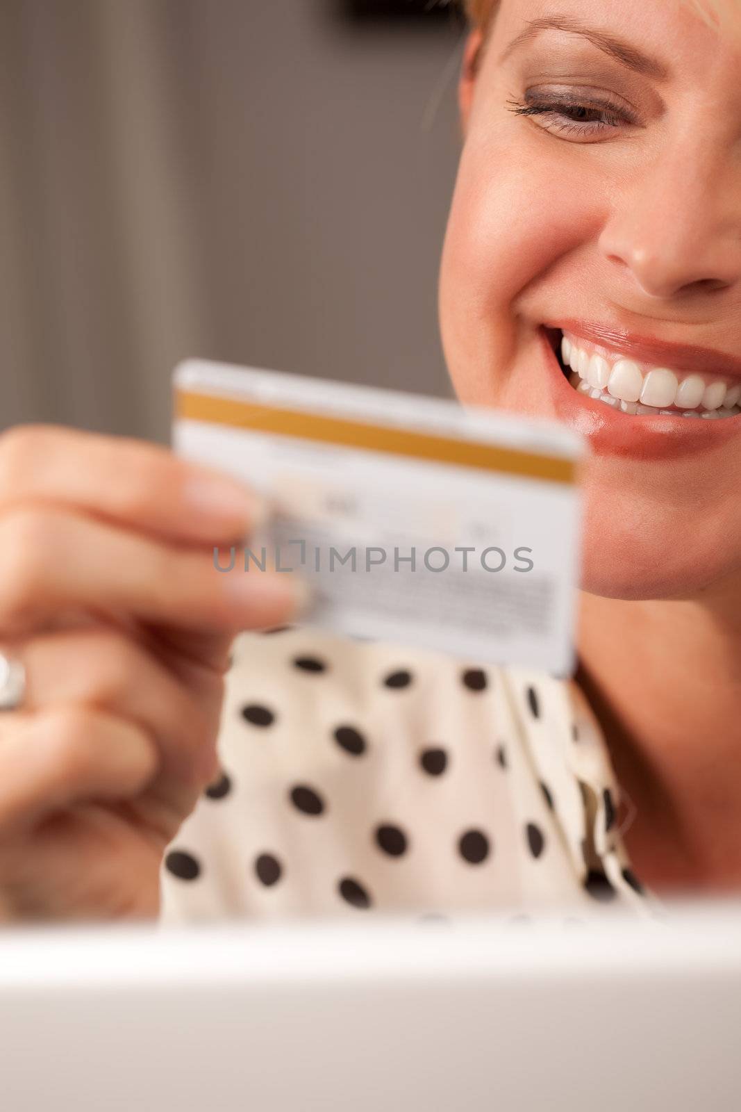 Beautiful Woman on Her Laptop Holding Her Credit Card.