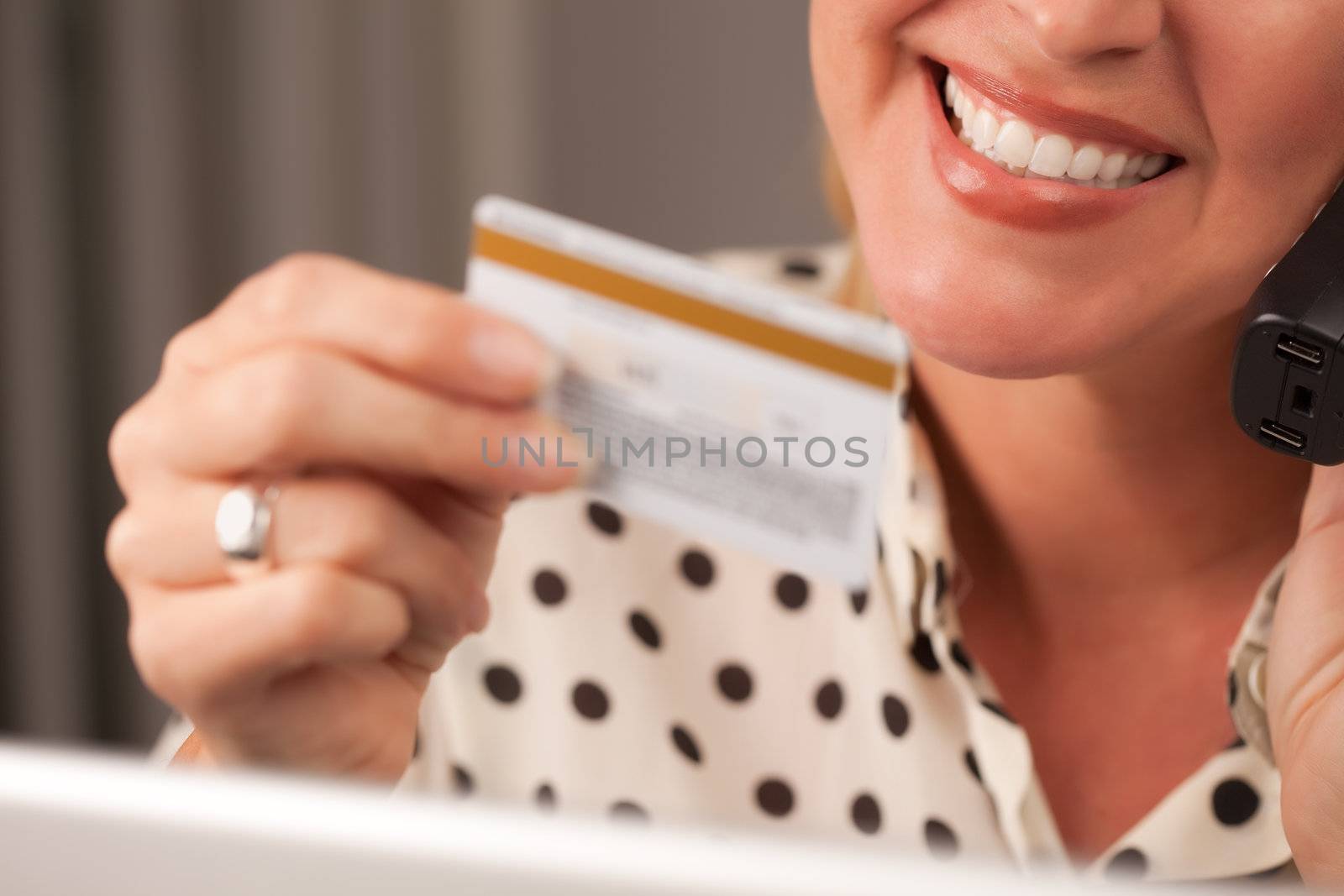 Beautiful Woman on Phone Holding Credit Card by Feverpitched