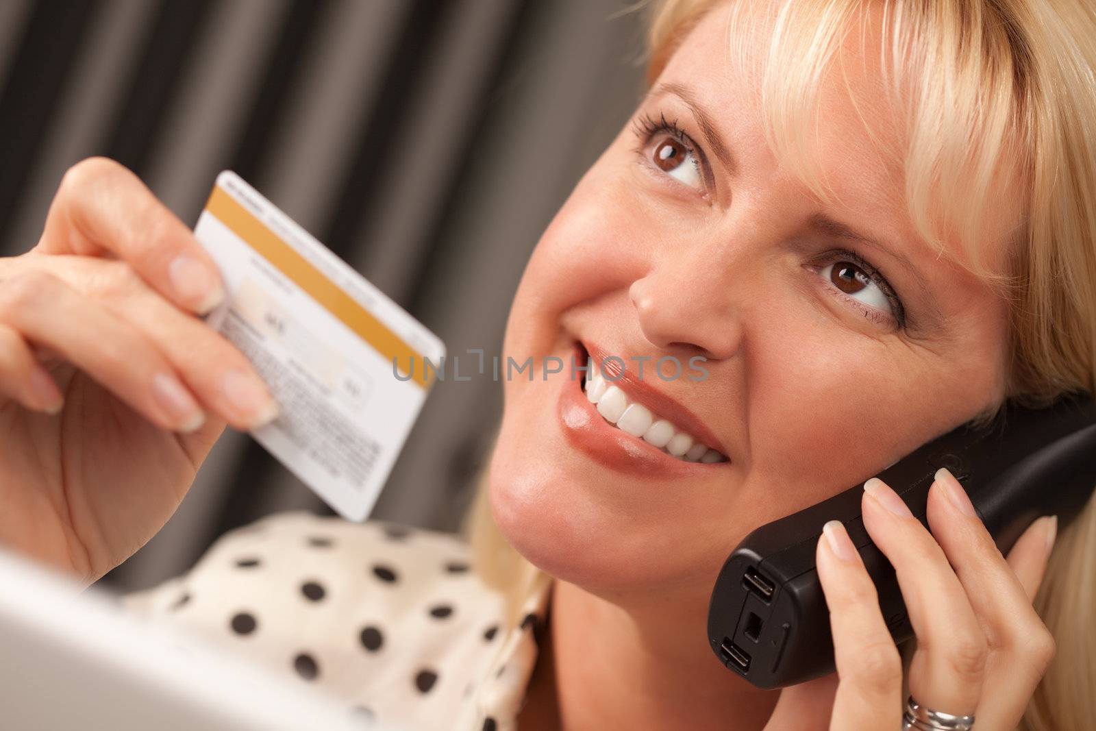 Beautiful Woman on Phone Holding Credit Card by Feverpitched