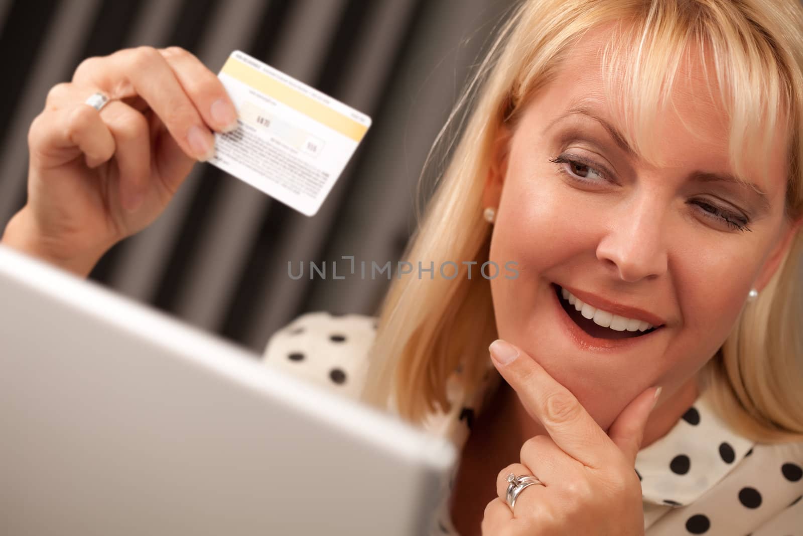 Beautiful Woman on Her Laptop Holding Her Credit Card.