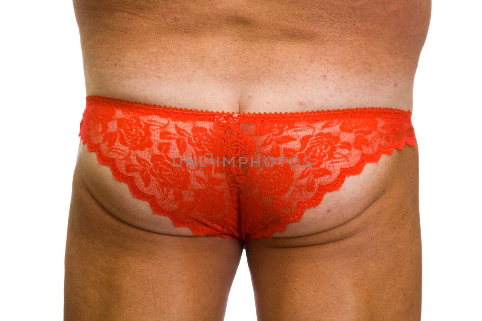 Male ass in red fishnet women's panties on a white background