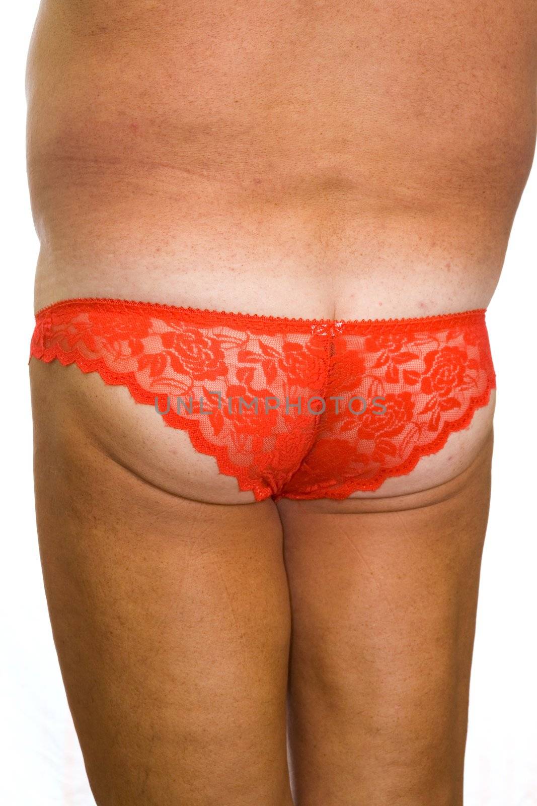 Male ass in red fishnet women's panties on a white background