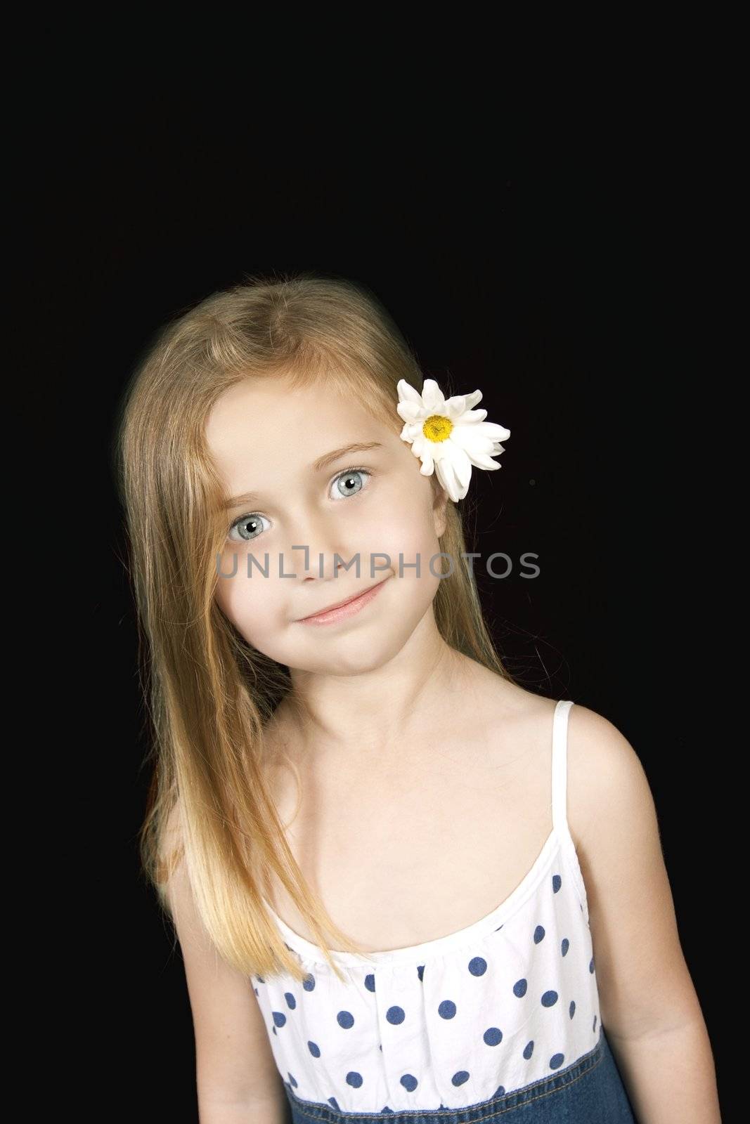 Young girl with blue eyes and flower in hair
