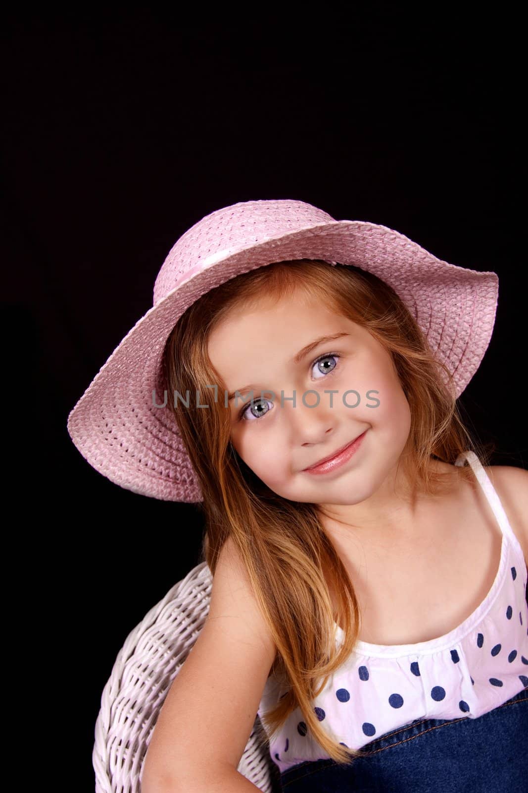 Pretty young girl with blue eyes and pink hat