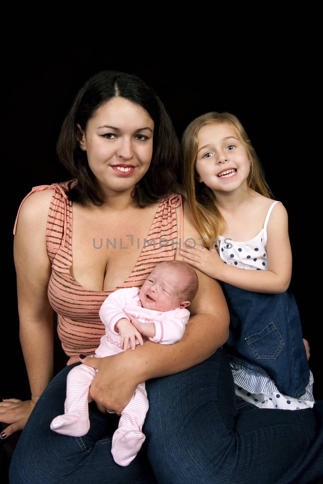 Family of with newborn baby on blackbackground
