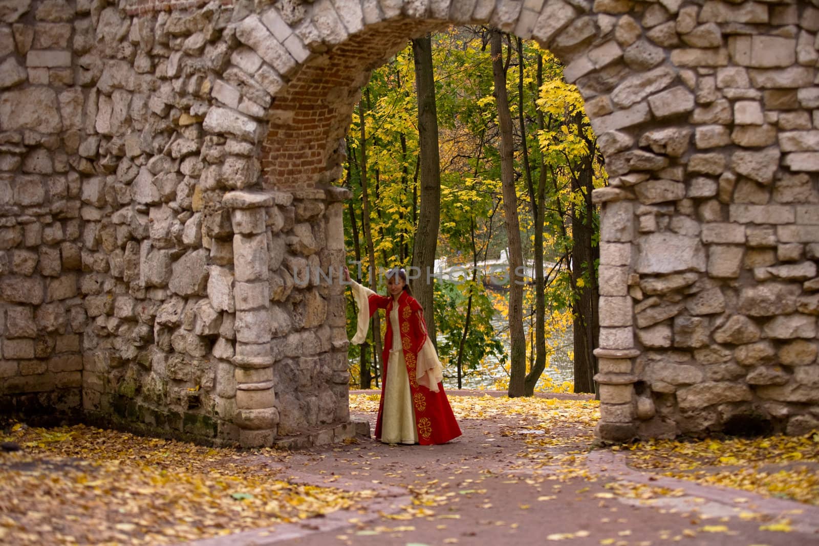 lady in medieval red dress standing in doorway
