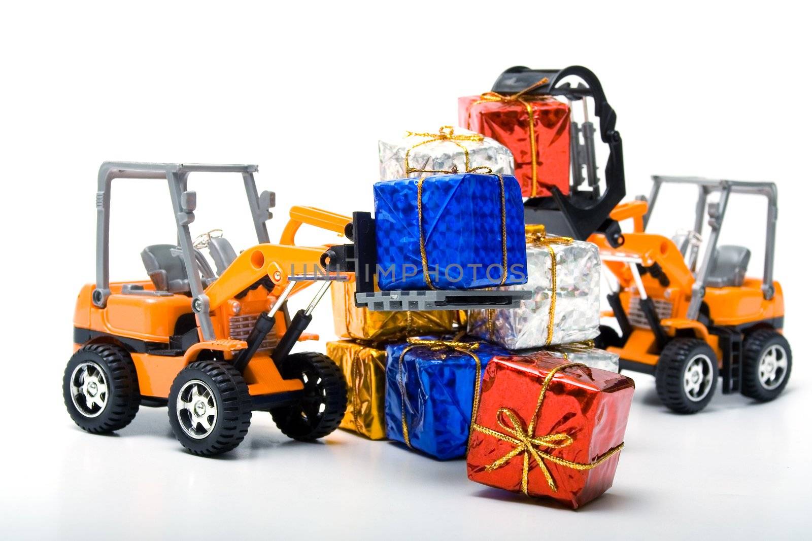 Model toy trucks shifted gifts wrapped in shiny colored paper and tied with gold rope