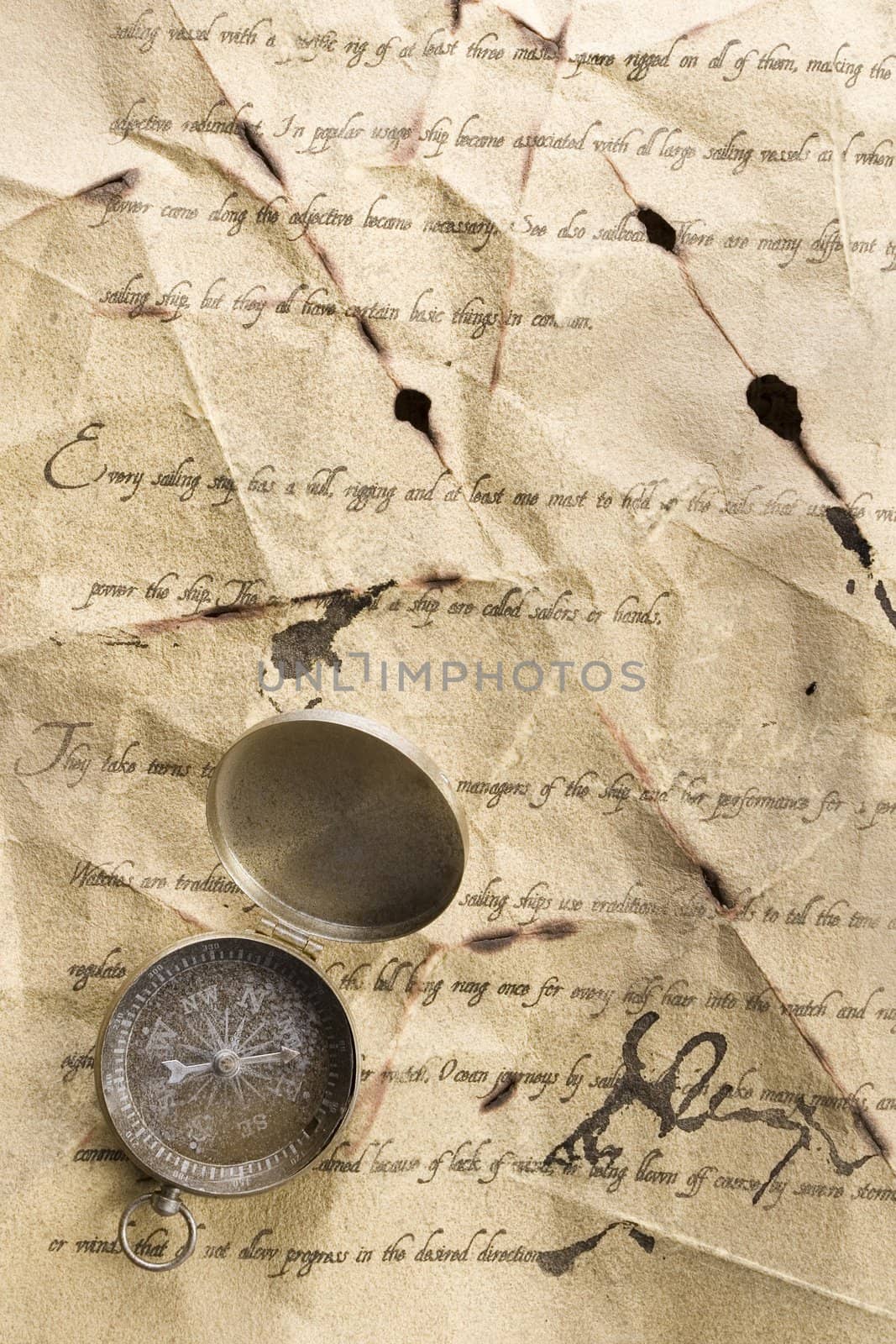 A beautiful old compass on an old letter