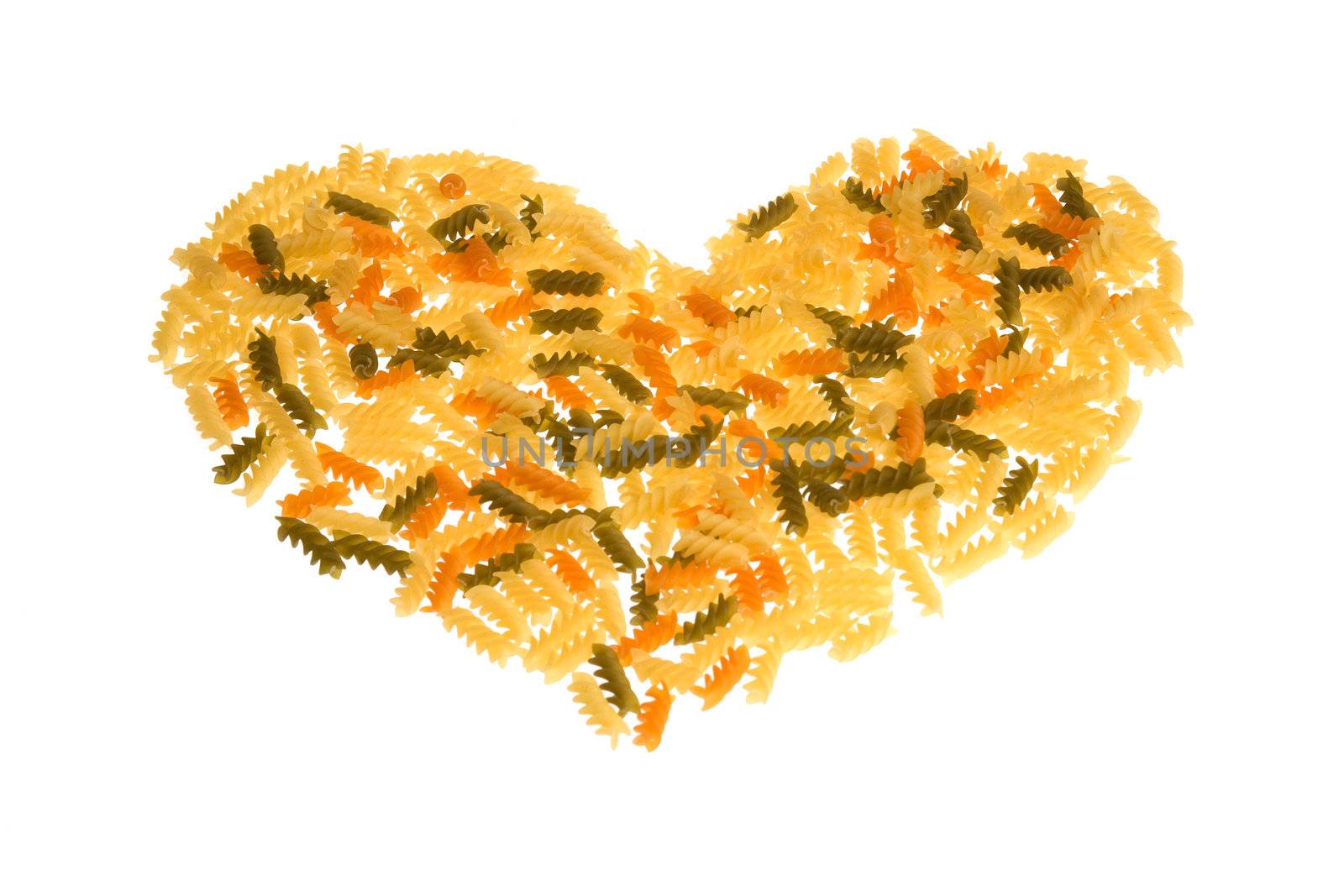 An assortment of uncooked pasta in a heart form over white background.
