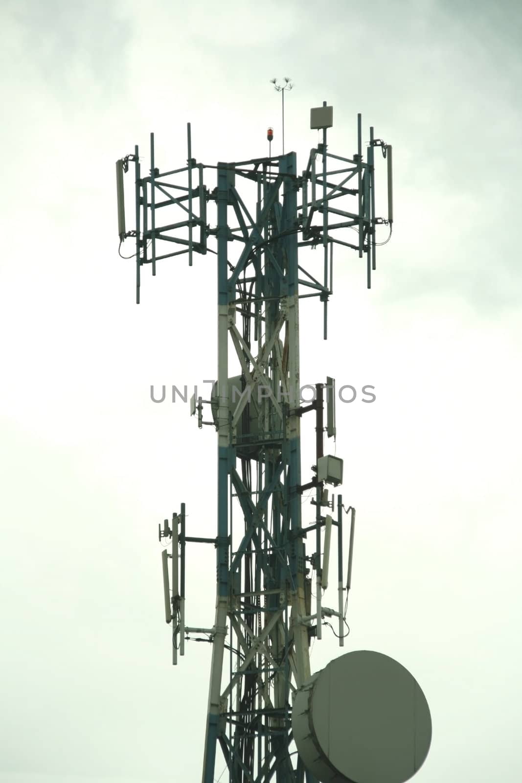 cellular communication tower on a cloudy day
