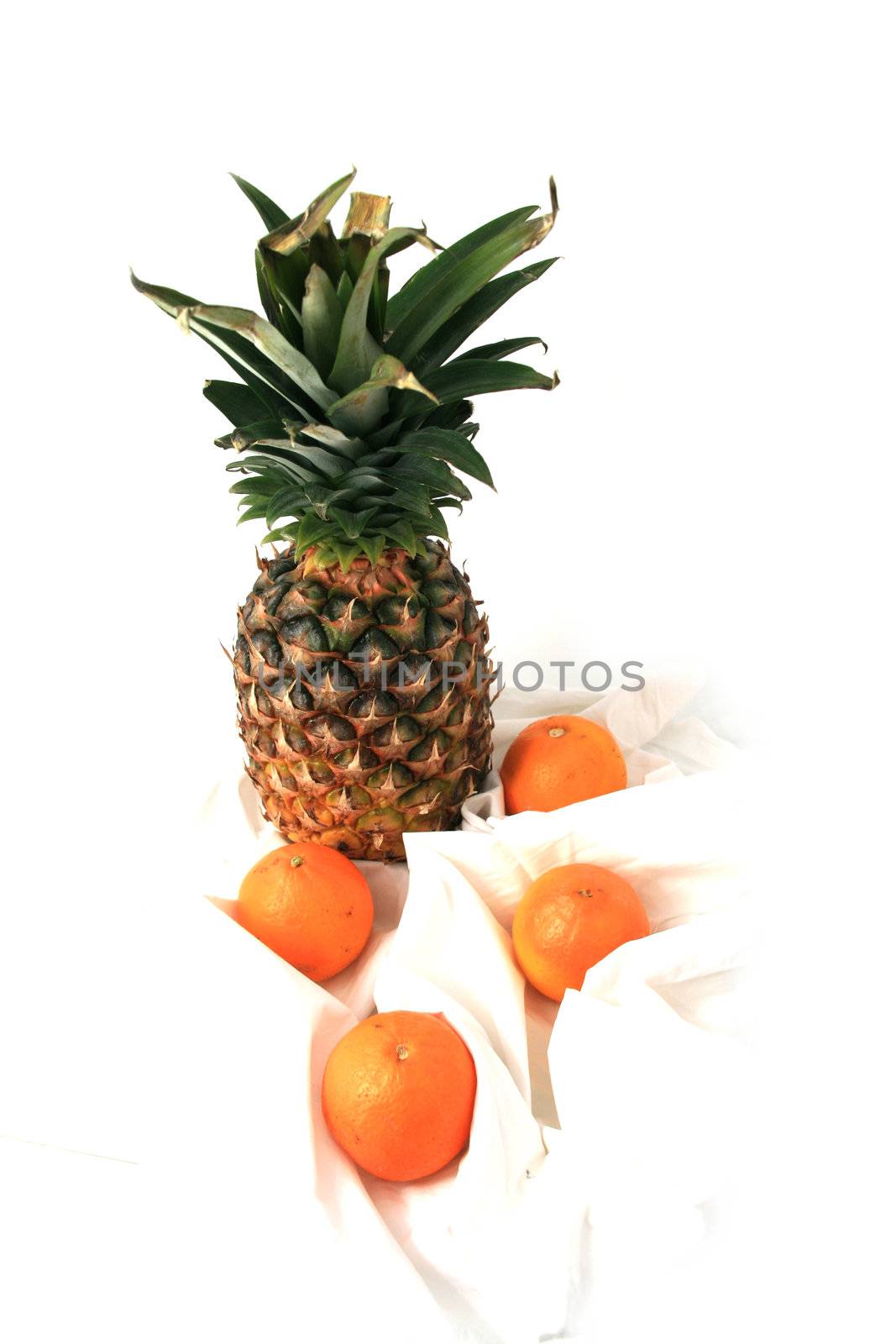 pineapple and oranges over white background