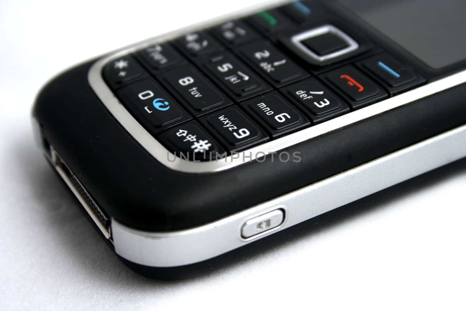 Close-up of cellphone keypads on white background.